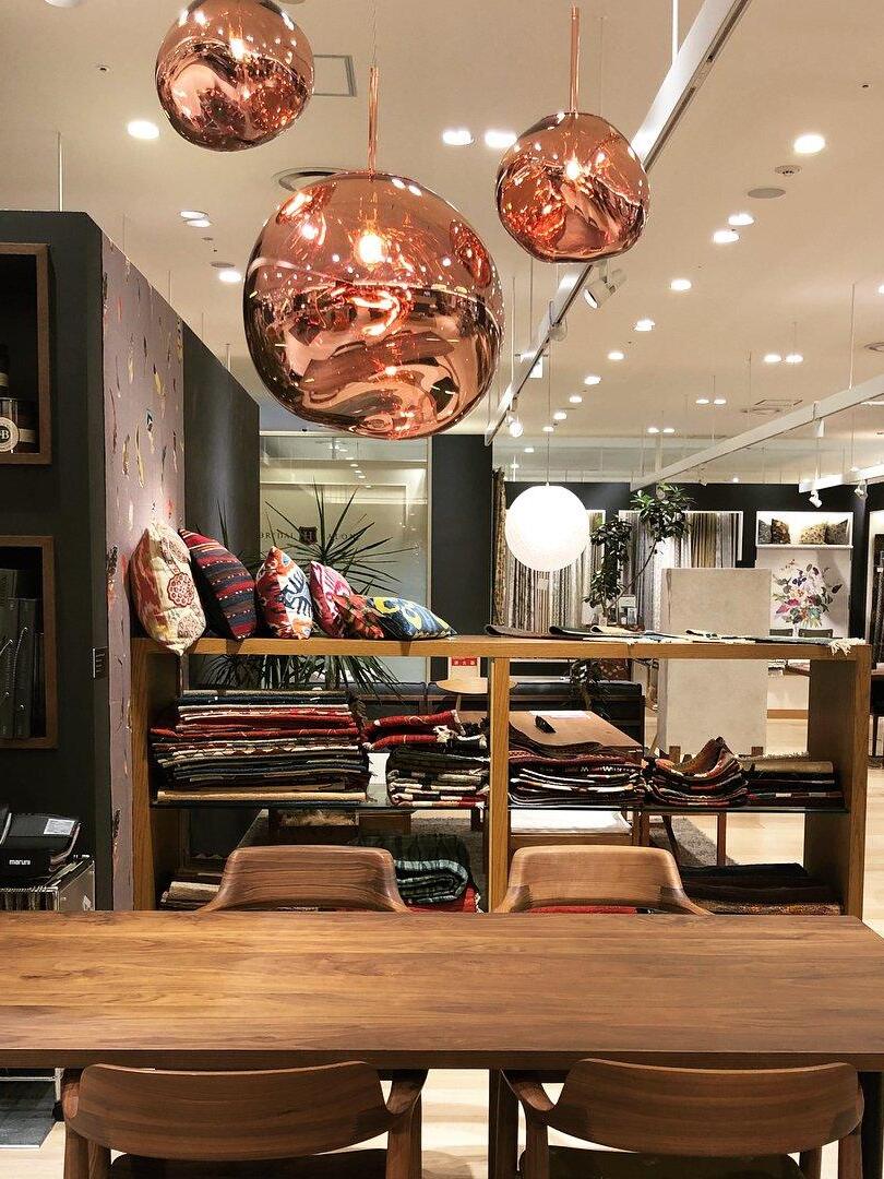 Copper-toned pendants above a dining table