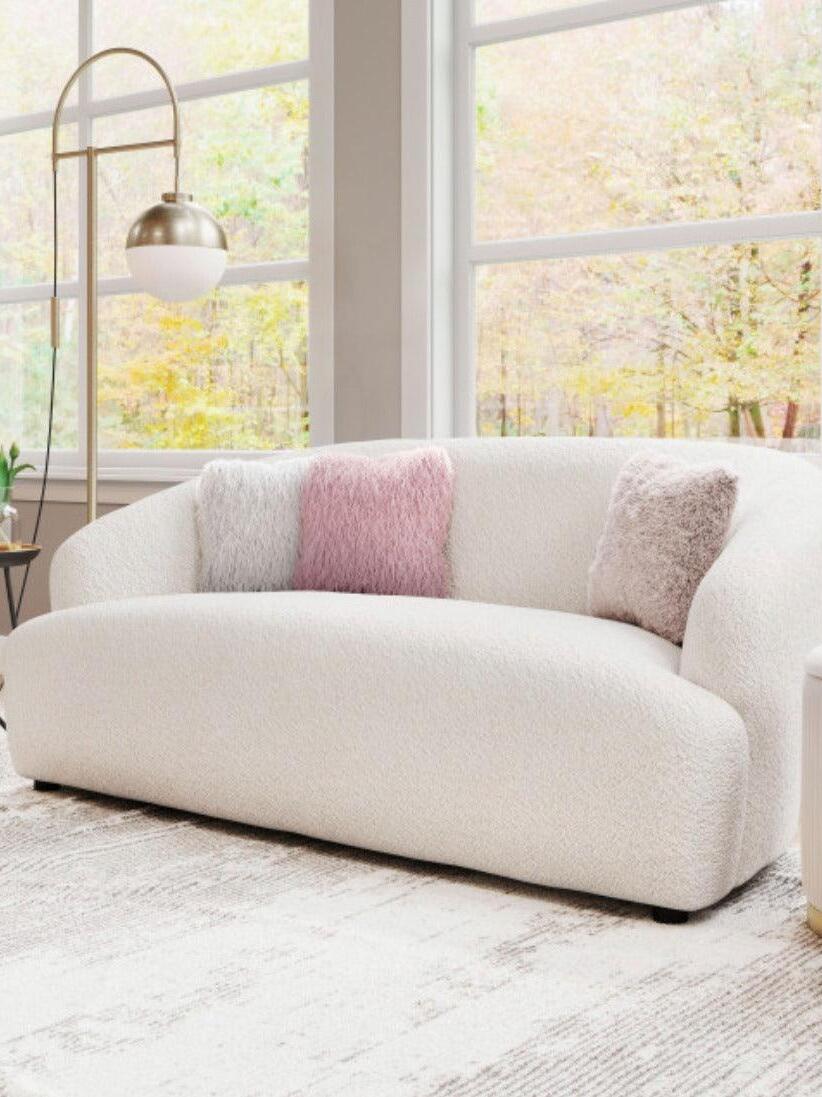 Waterloo Gold floor lamp beside a curved white sofa