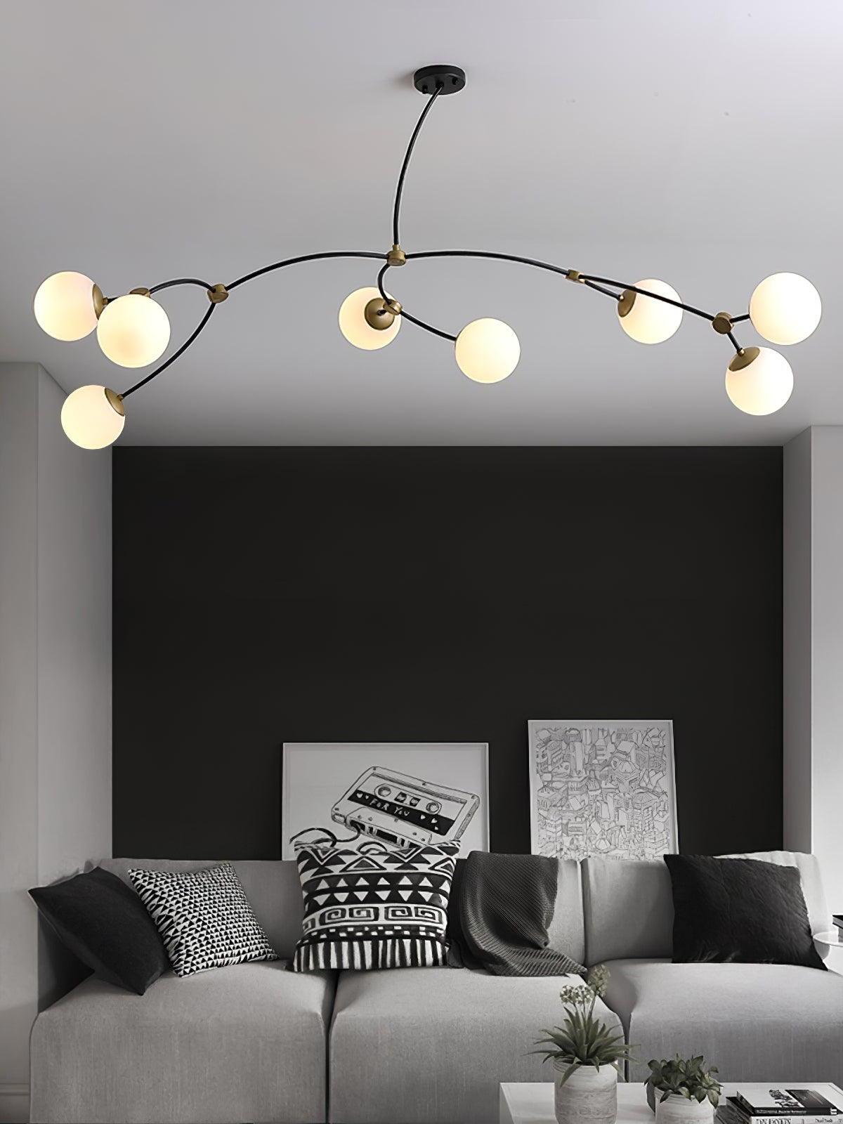 Wide white globe chandelier above a grey sofa