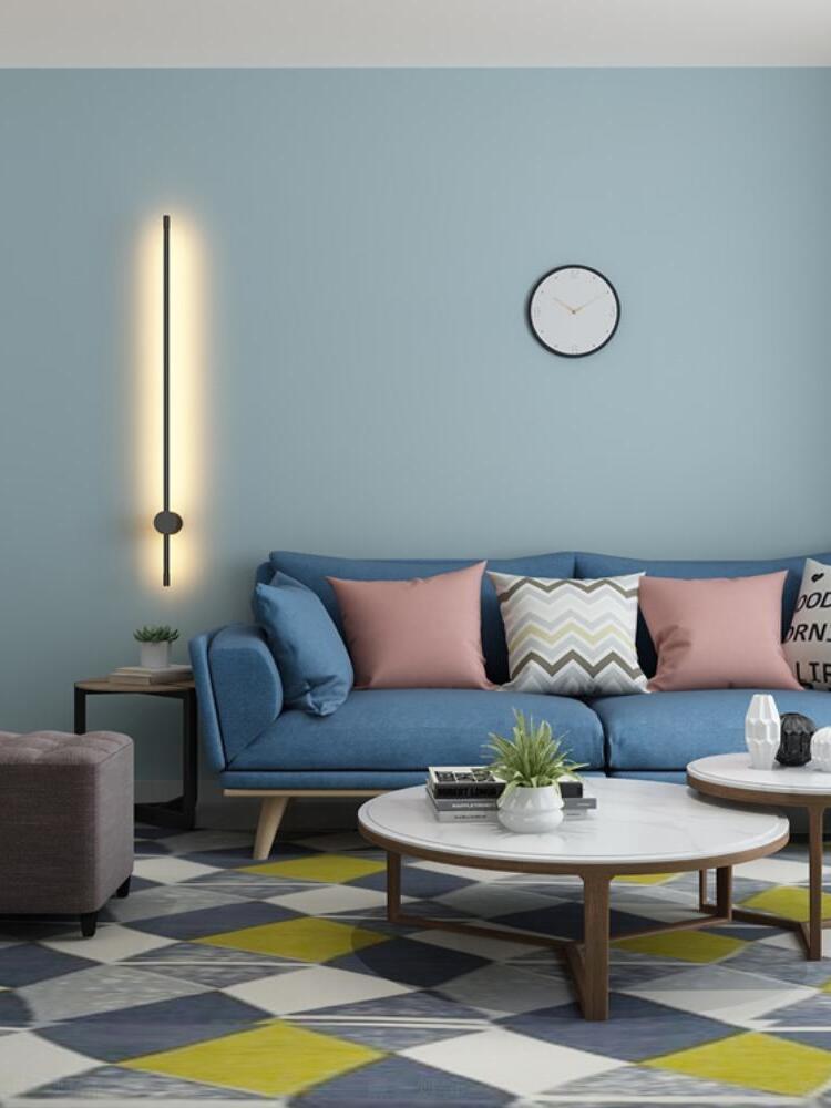 Vertical light beside a blue sofa