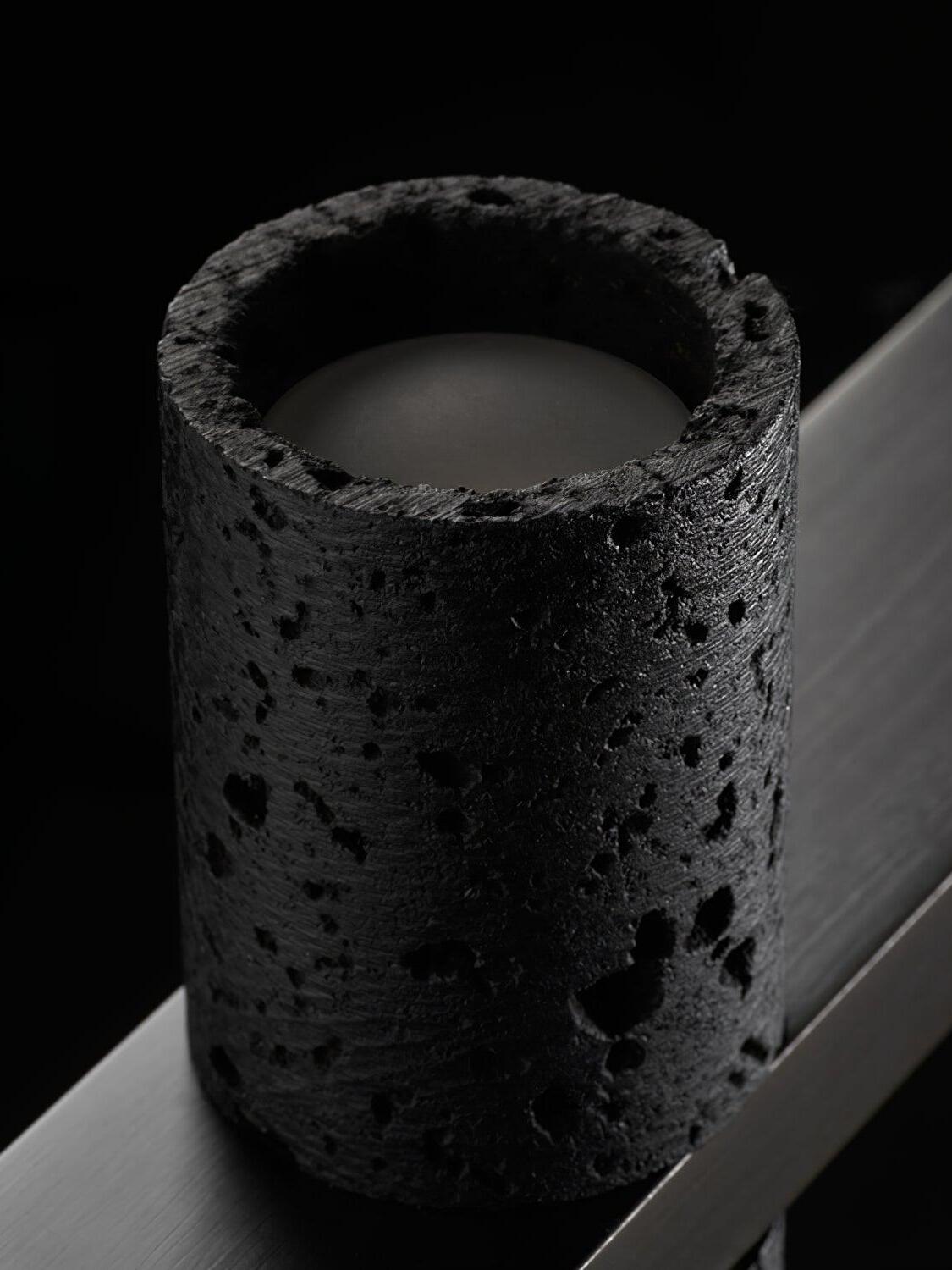 Porous black cylinder with recessed upper light surface