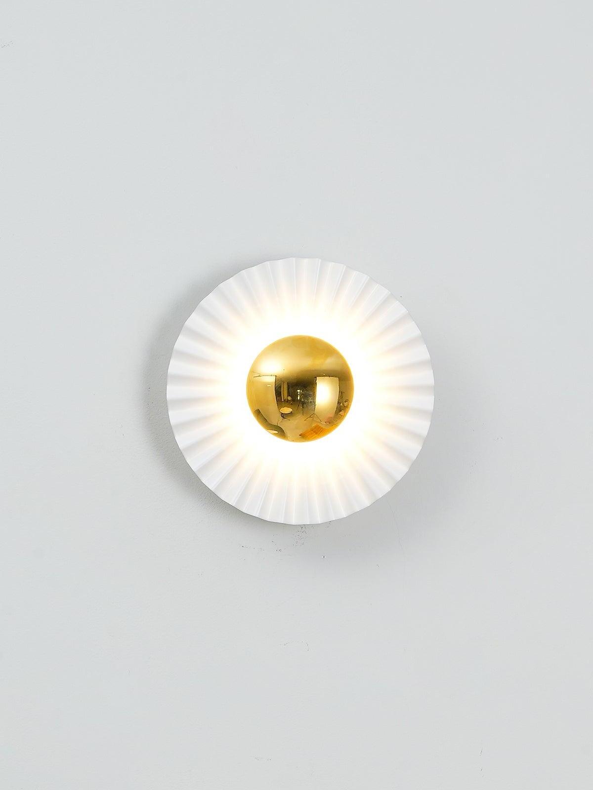 Single illuminated radial wall light on pale wall