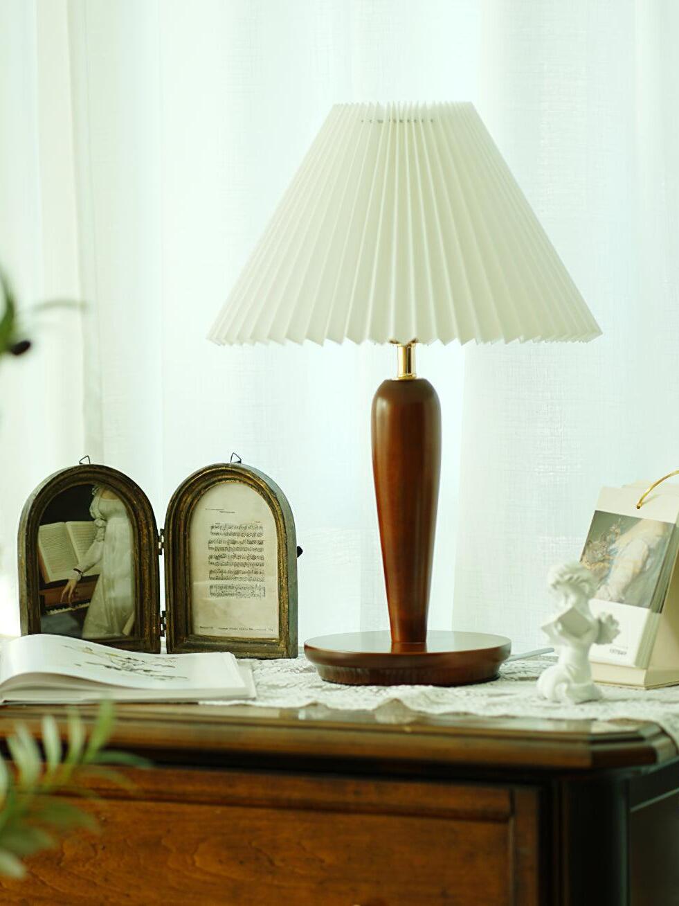 Brown Brentwood lamp with white pleated shade on dresser