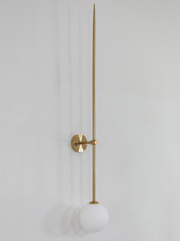 Angled unlit gold-tone linear wall light showing its short arm, round plate and white globe