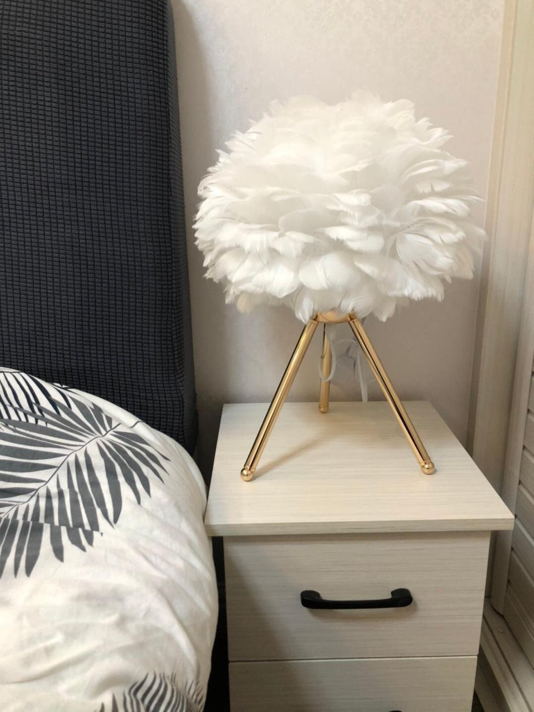 White feather lamp on compact nightstand