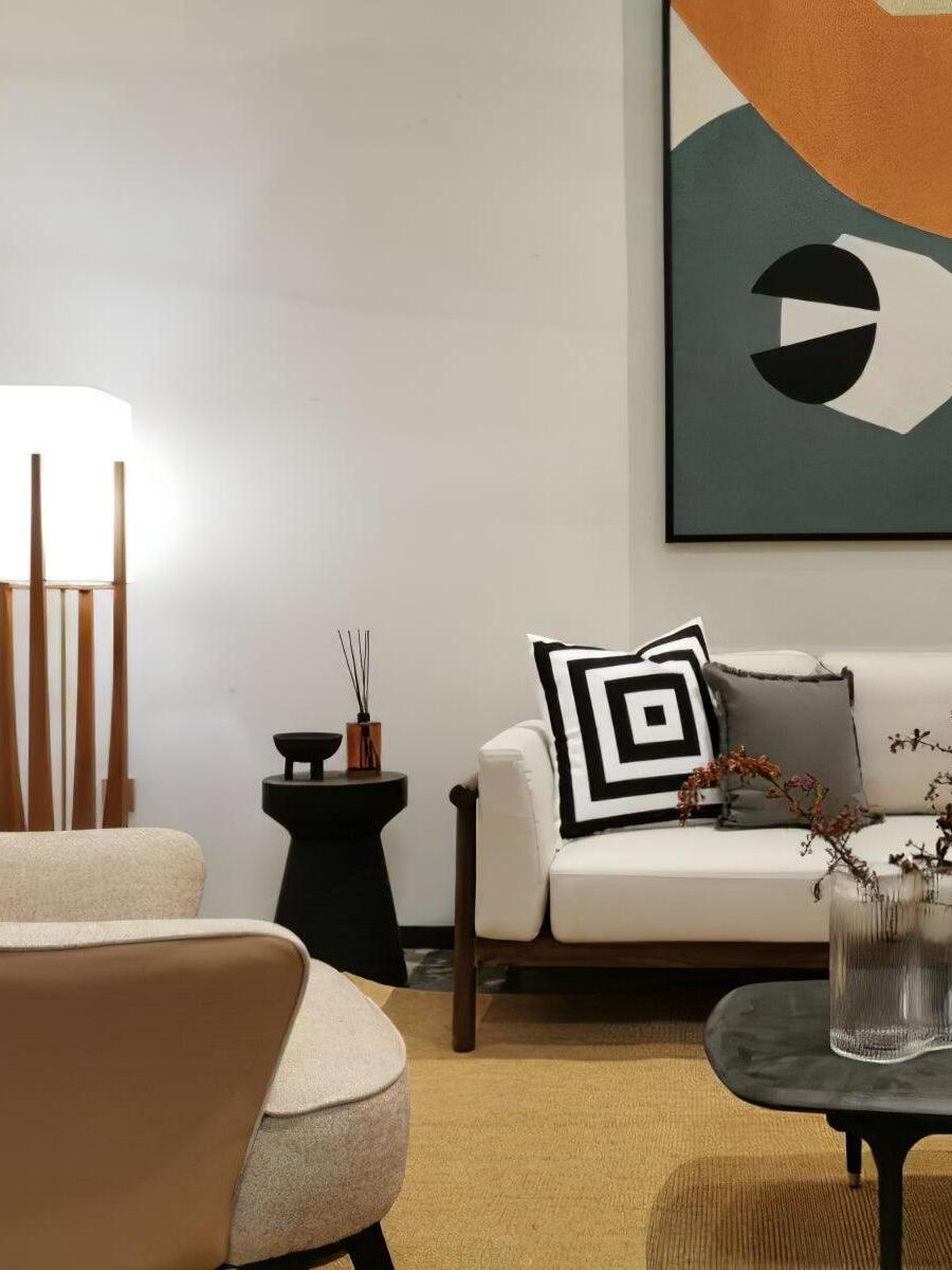 Tall fabric shade lamp beside seating