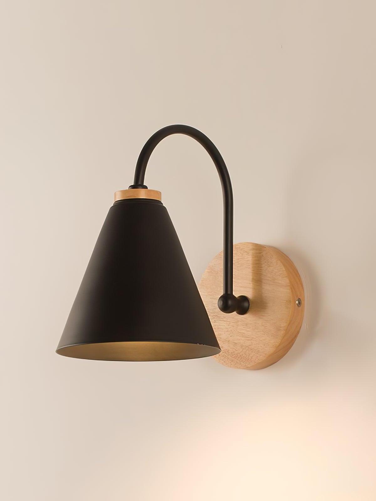 Black Kona wall lamp with curved arm and round wood plate