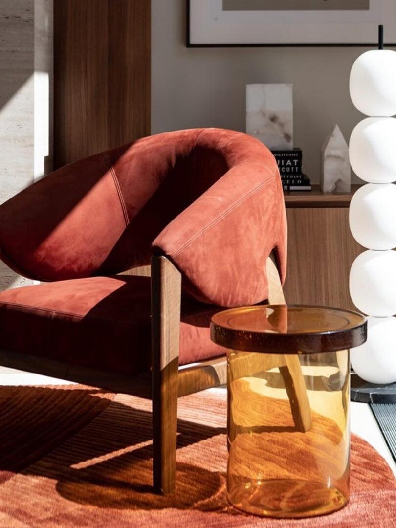 Partial white globe lamp behind red chair