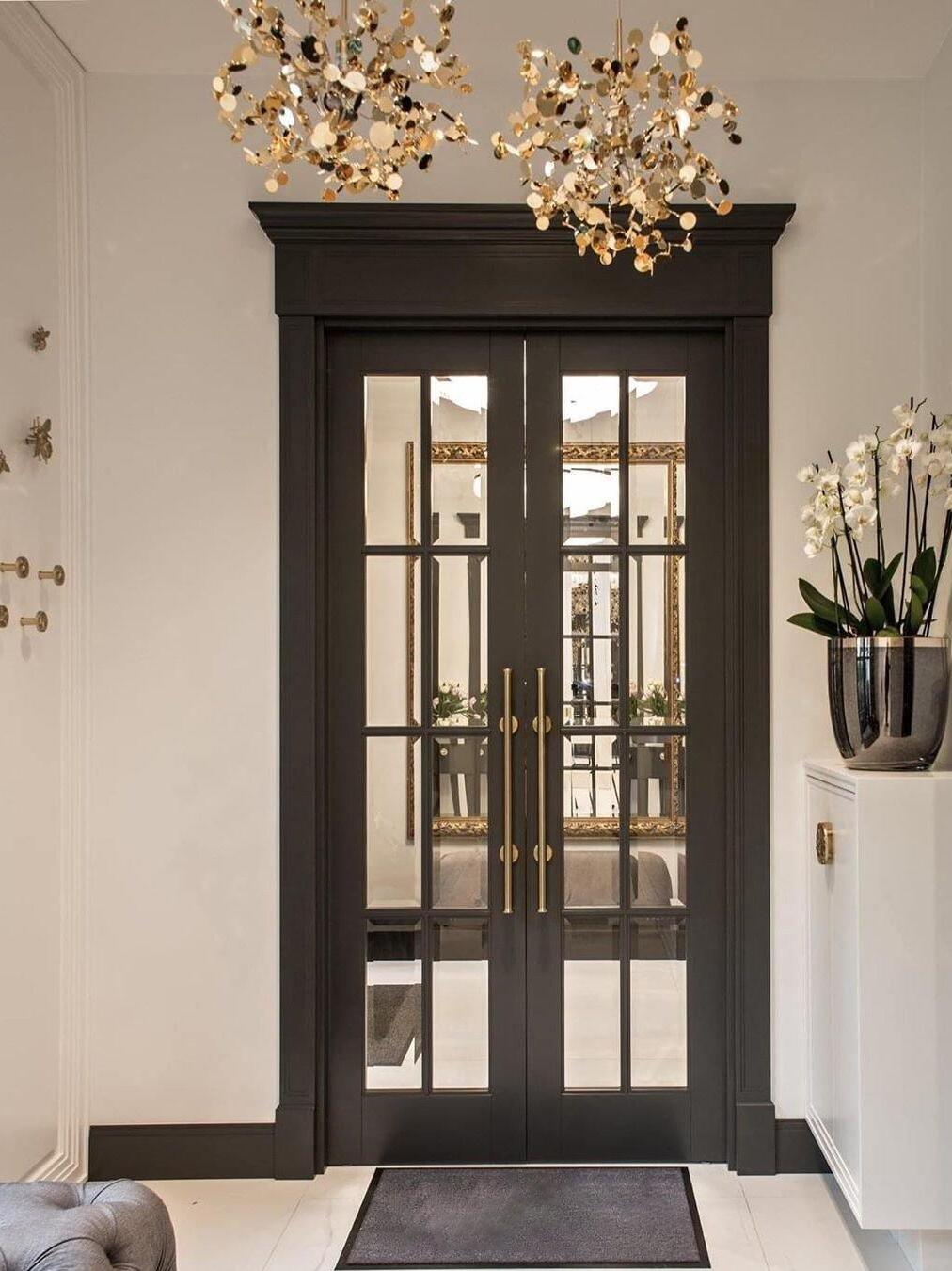 Two gold-toned disc clusters hanging above a dark doorway