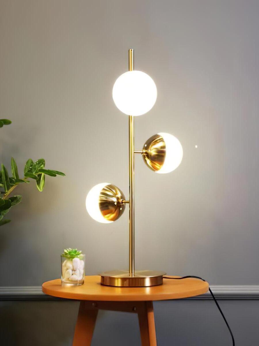 Short gold globe lamp on round side table