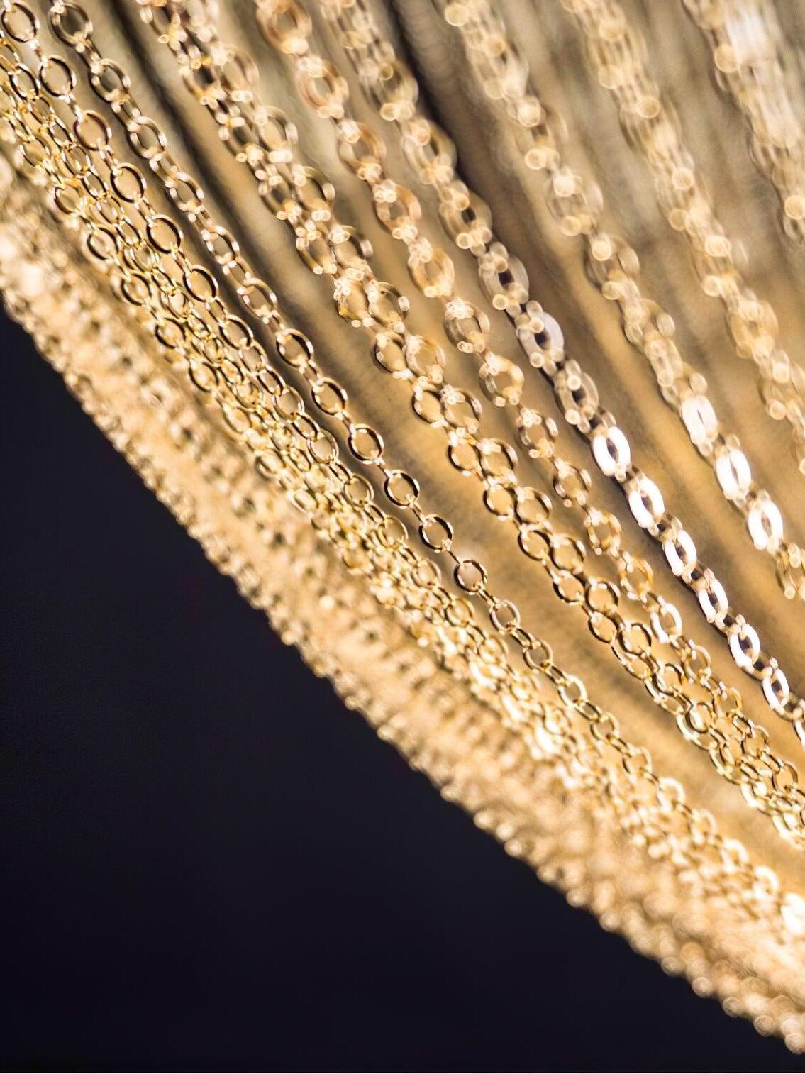 Macro view of interlinked gold-coloured metal chains