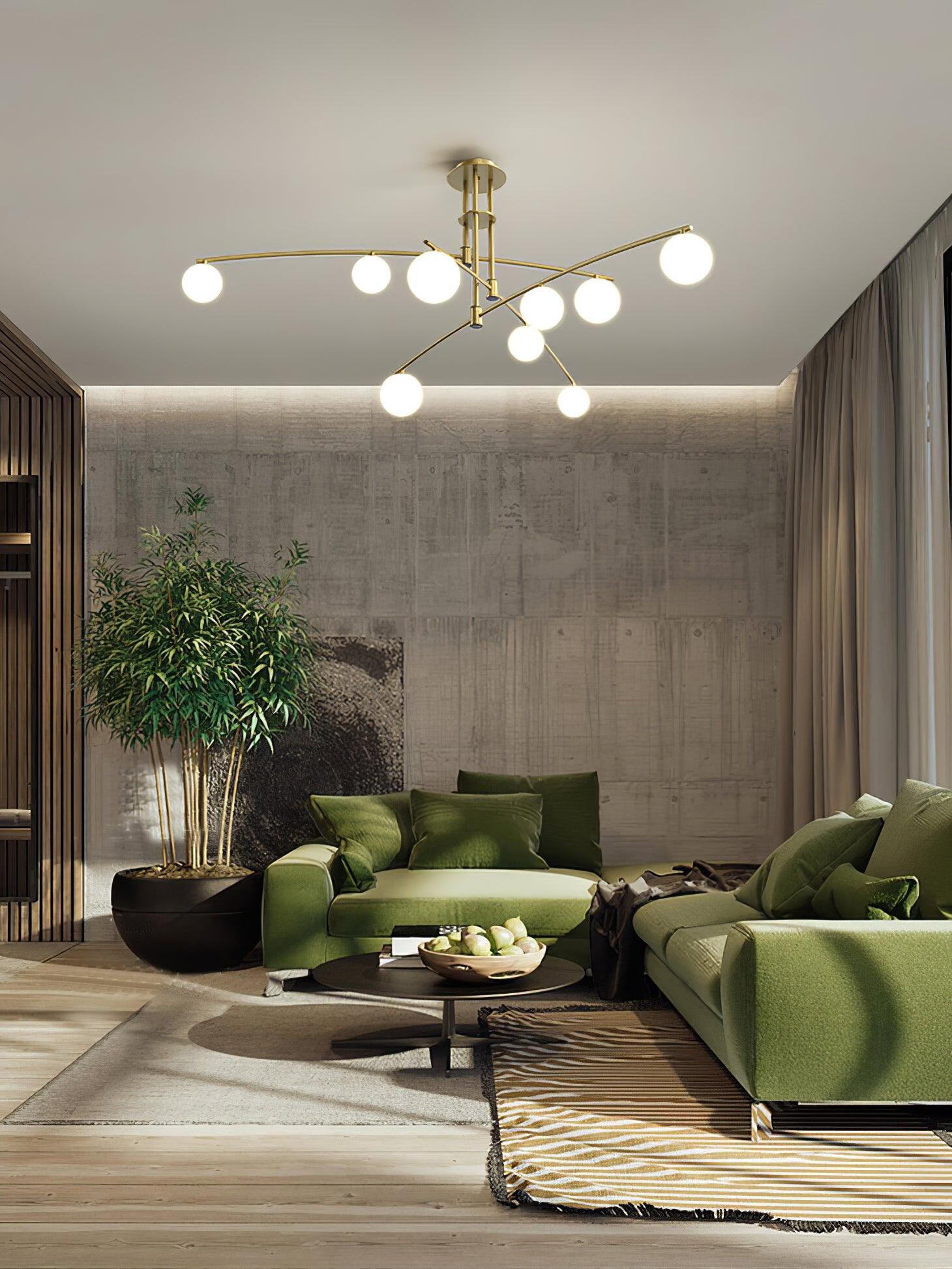 Gold globe chandelier over green seating