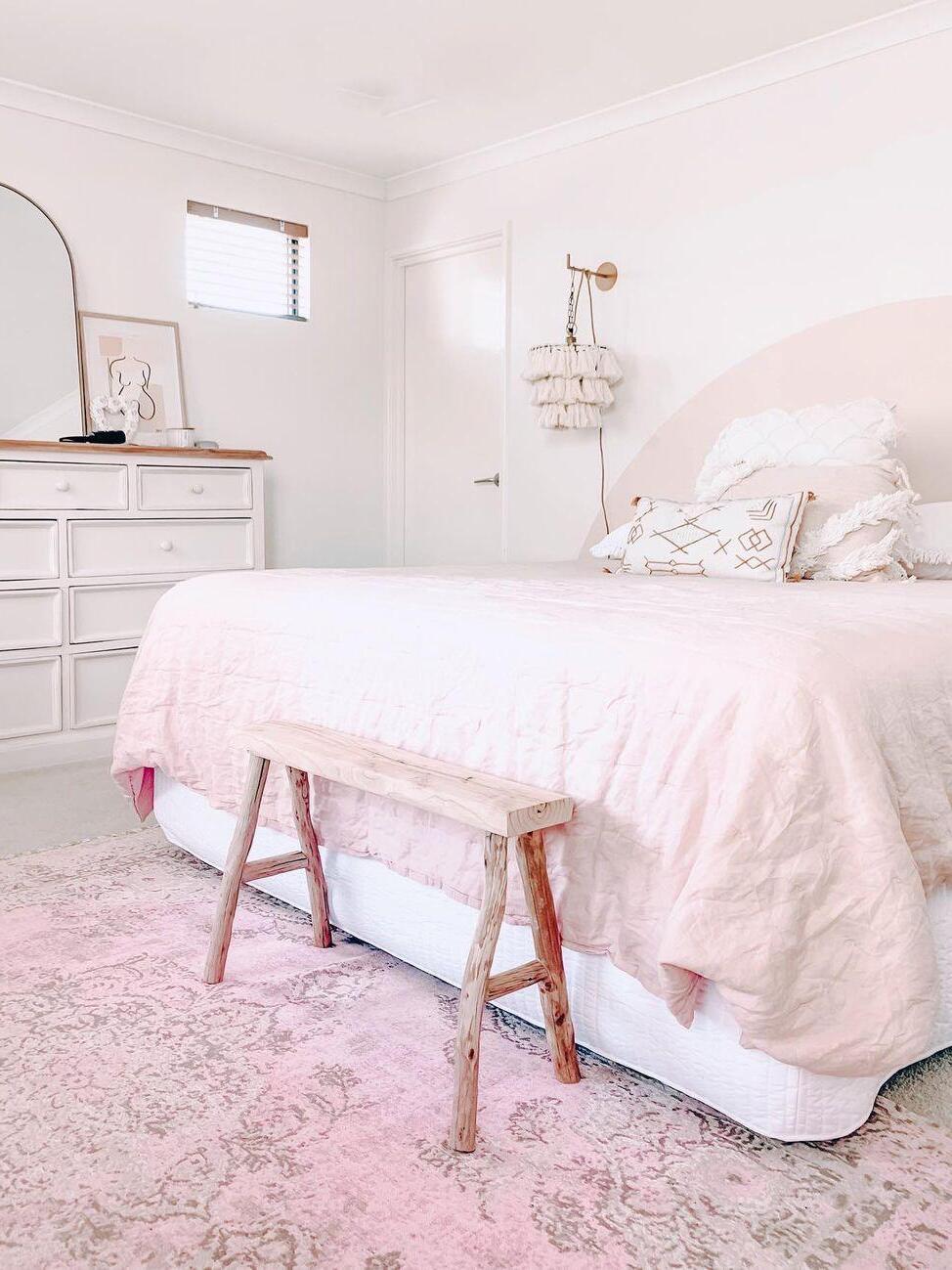 White tassel shade in a pale pink bedroom