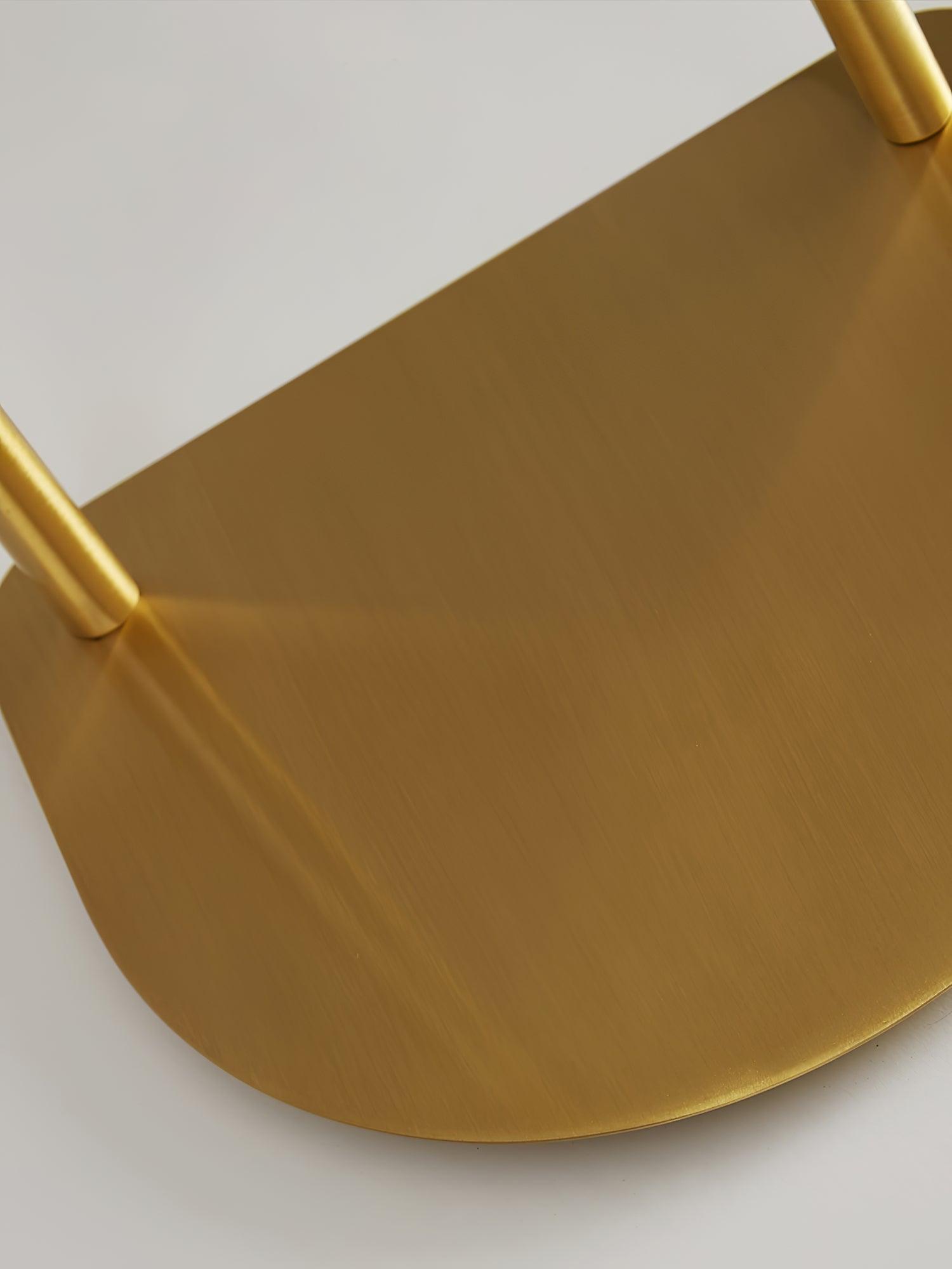Close view of round brass base and attached stems