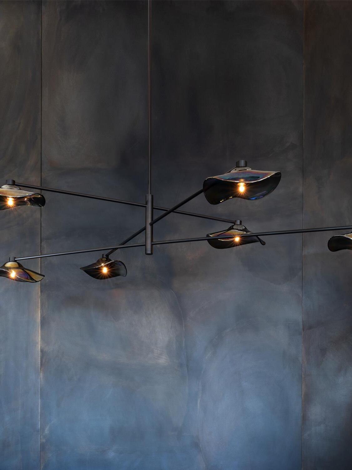 Black Calla chandelier against a dark wall