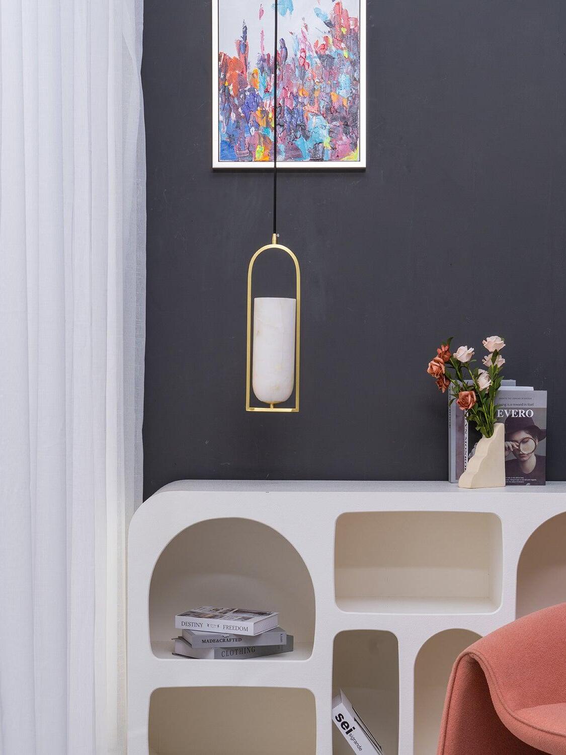 Unlit Melange pendant above a white console with flowers beside a pink chair