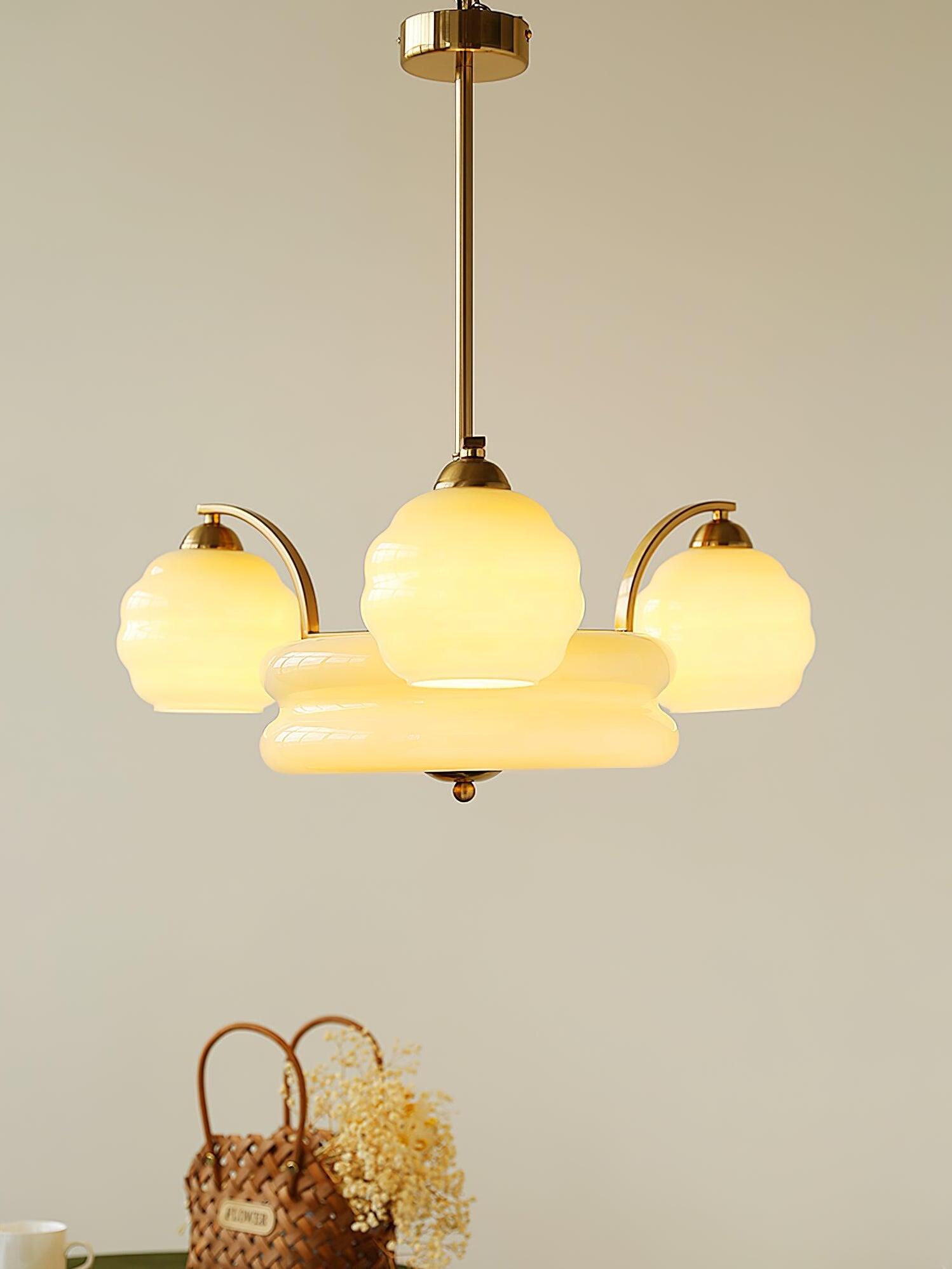 Illuminated Gold finish chandelier above a table