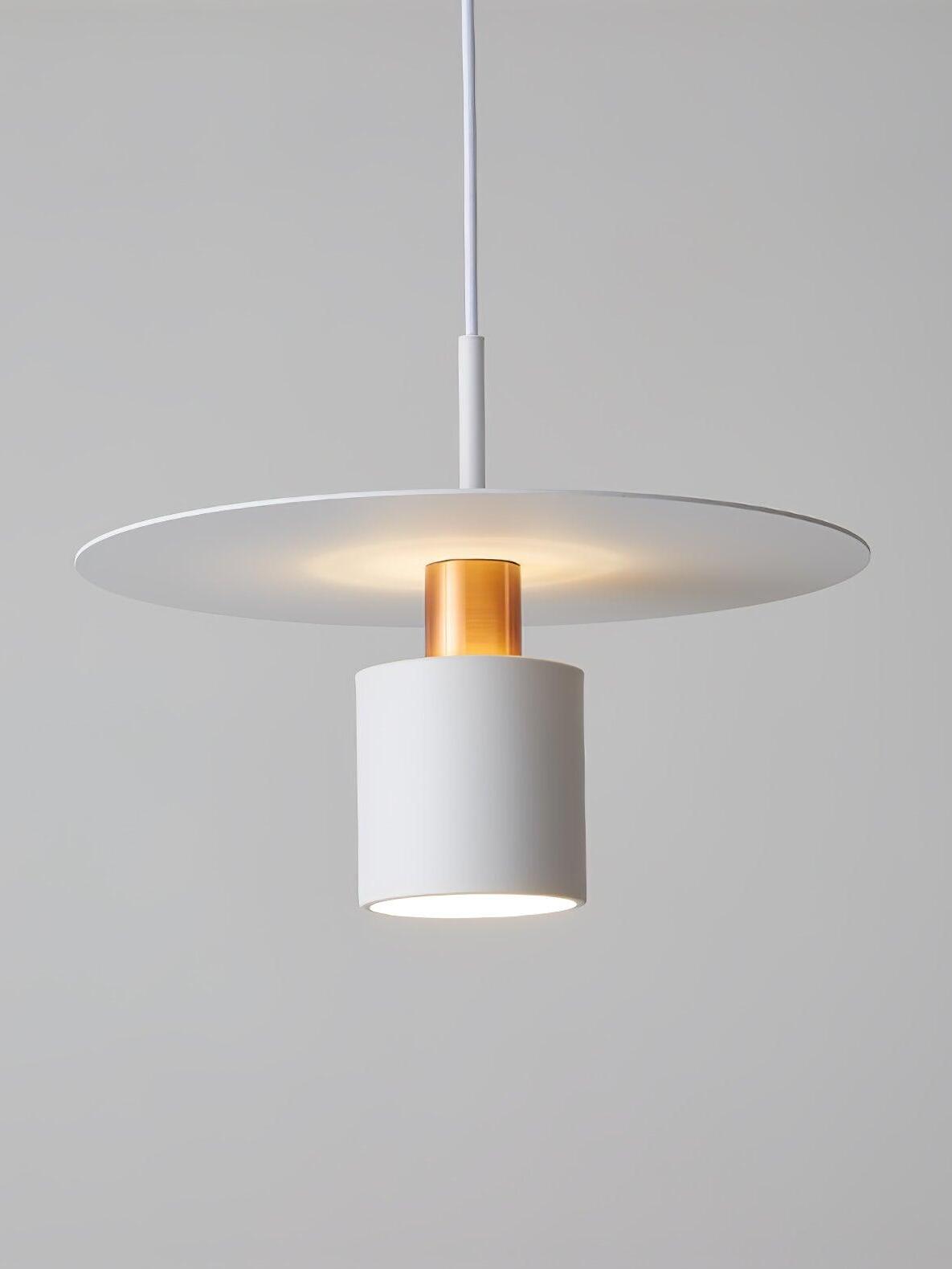 Close white cylinder and wide white metal disc