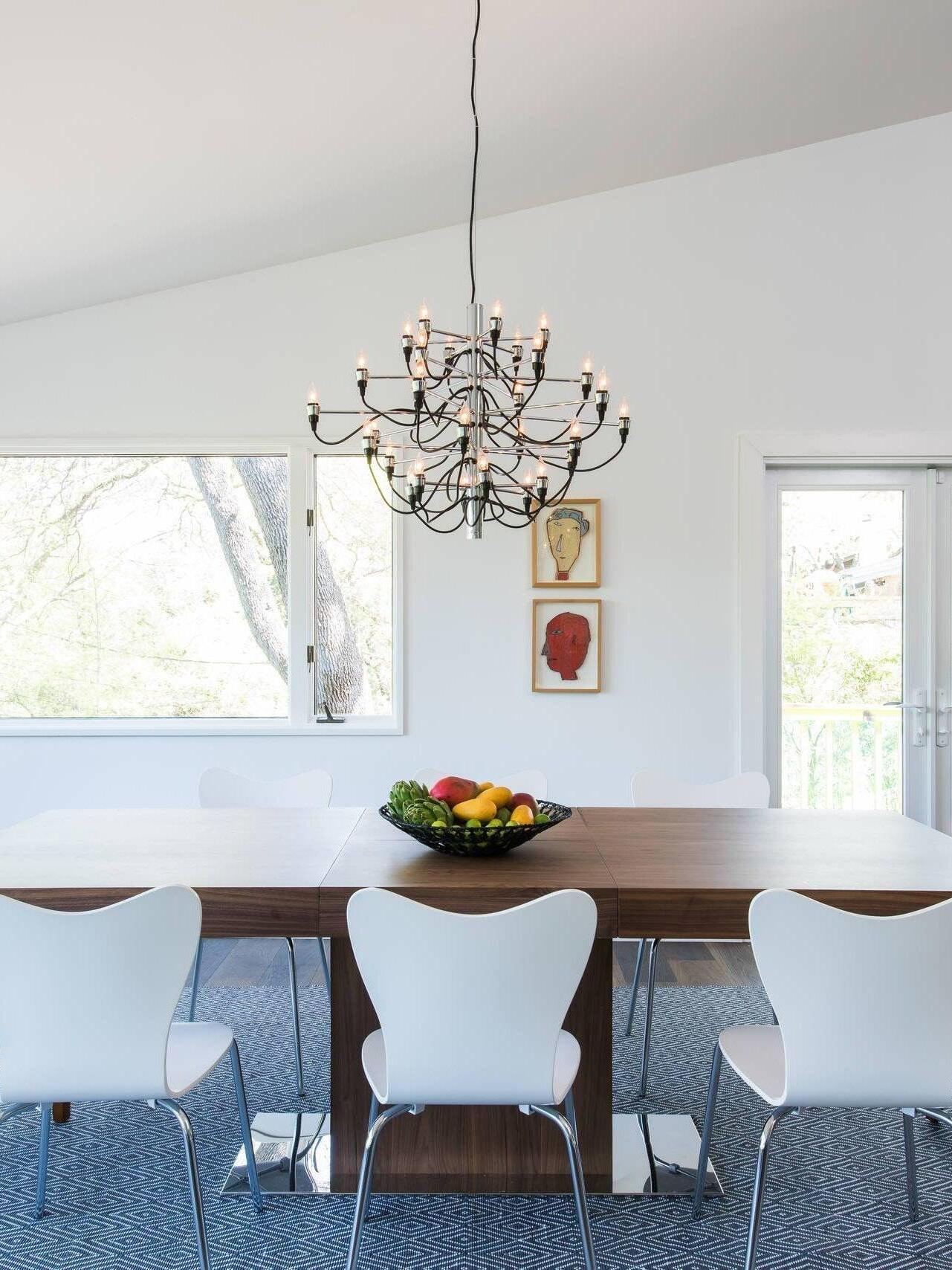 Chrome-looking chandelier in a White dining room