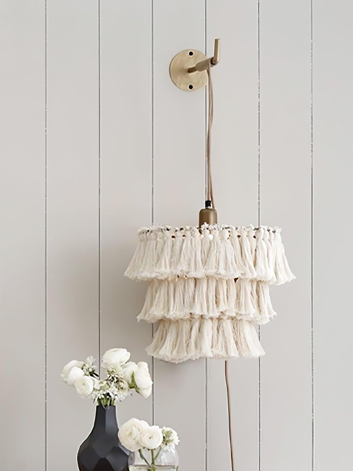 White three-tier tassel light on a wall