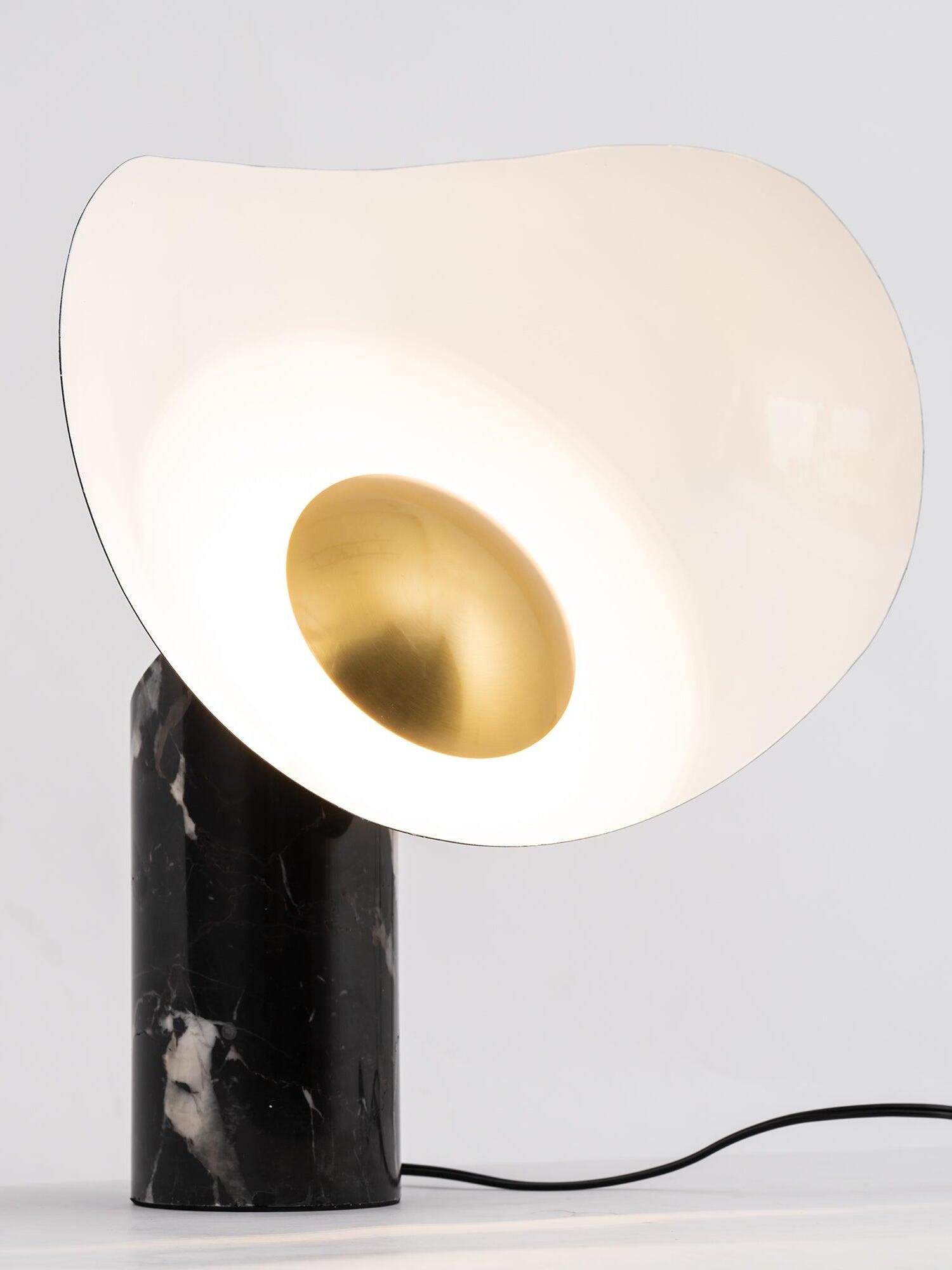 Angled view of glowing curved shade and black power cord