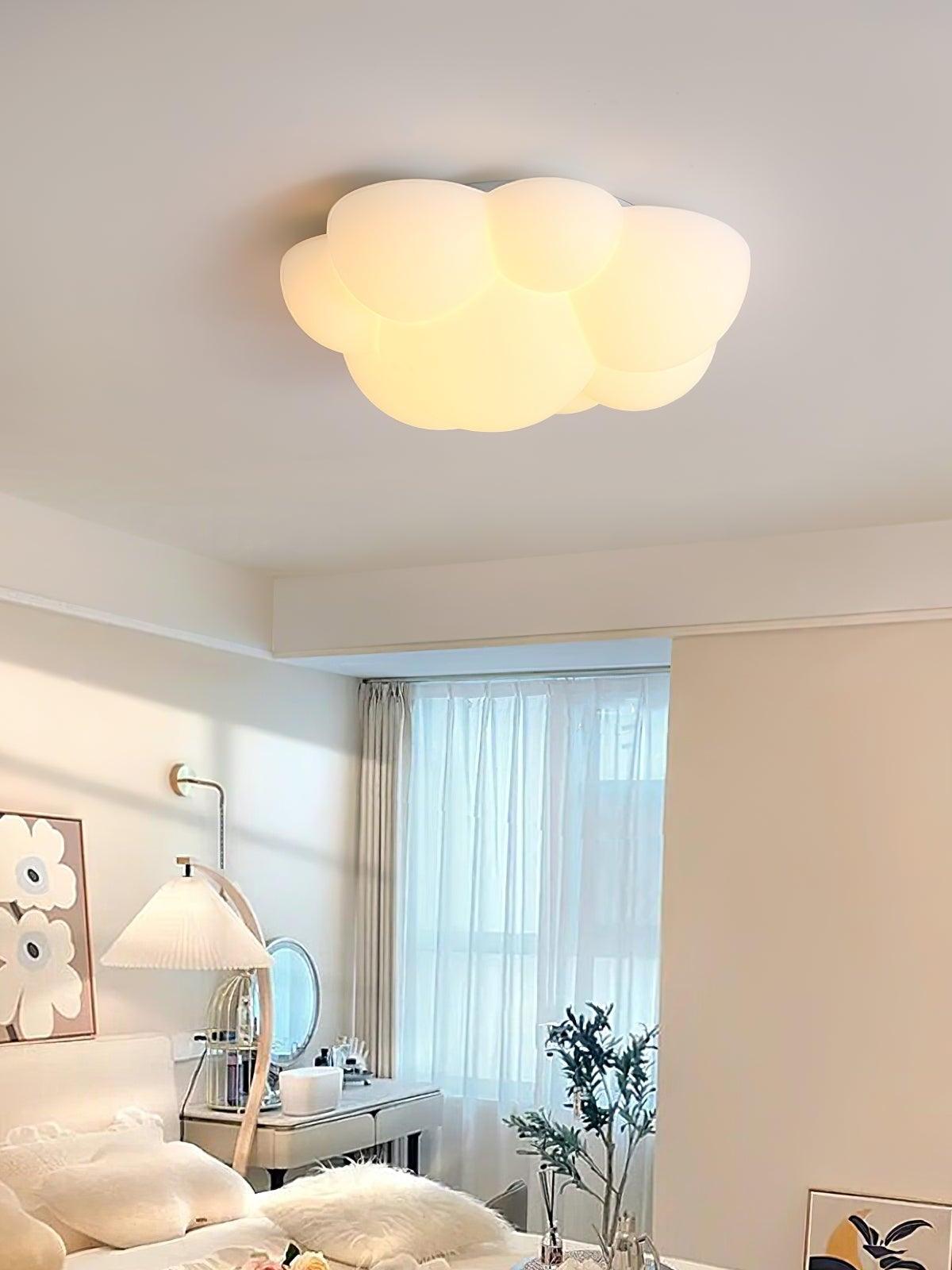 Nuage cloud ceiling light in a pale bedroom with a desk beside the window