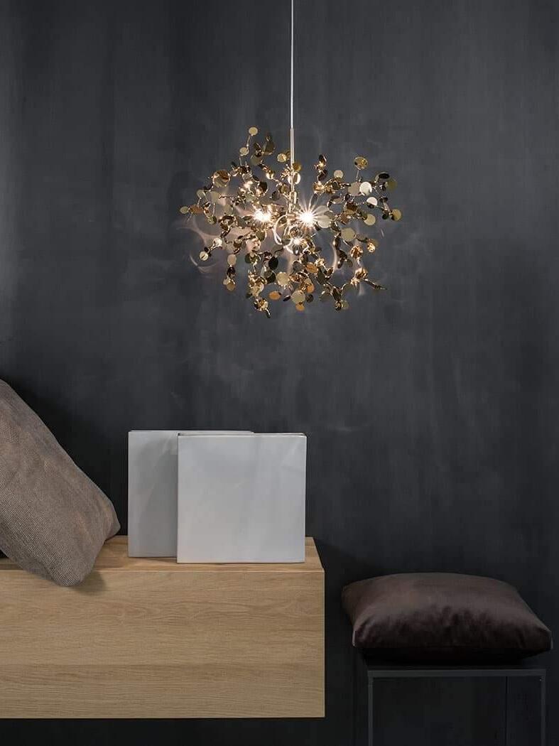 Gold disc cluster against a dark wall above a low cabinet