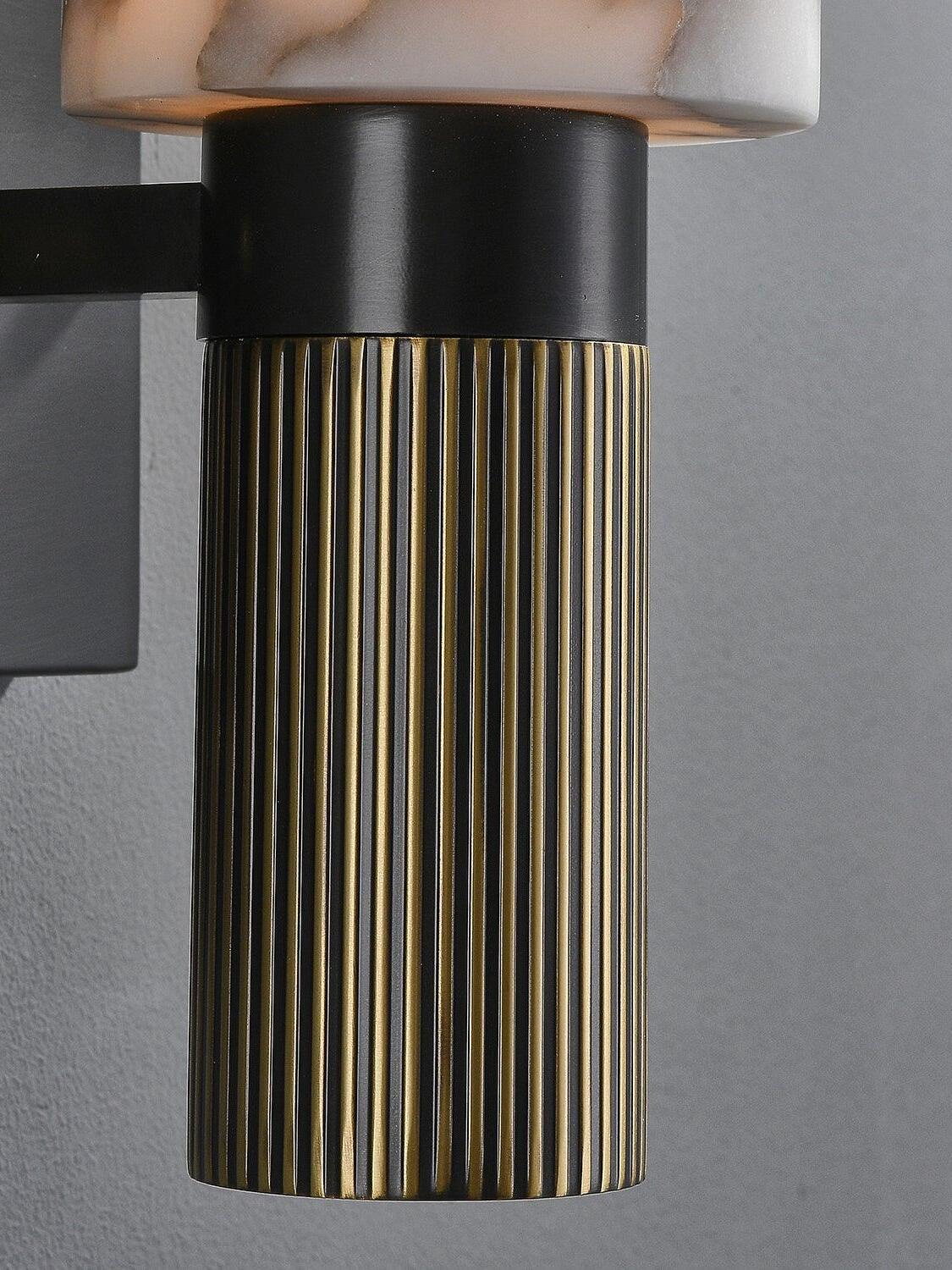 Vertical ribs on metal lower section of marble sconce