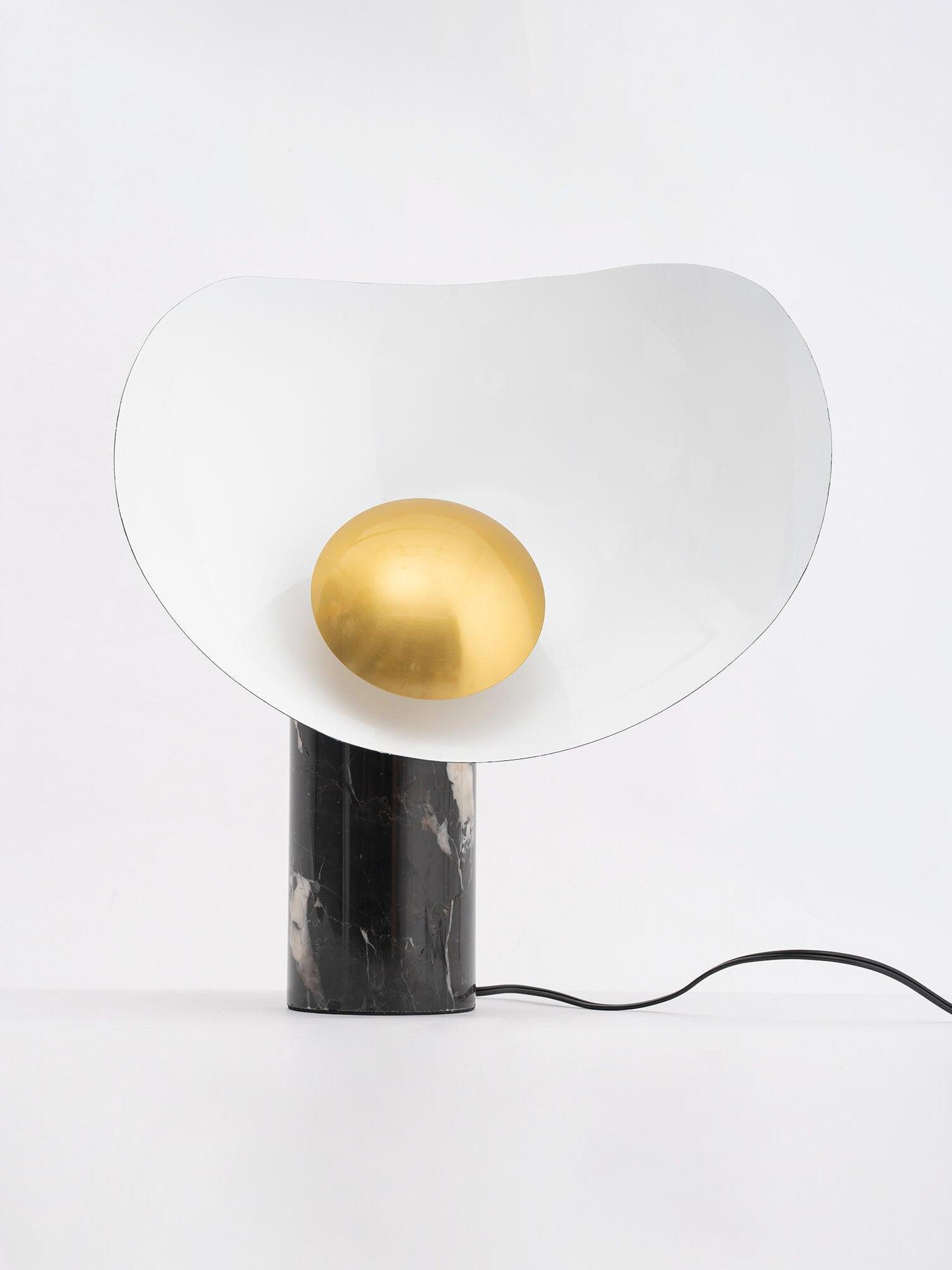 White and gold table lamp with trailing black cord
