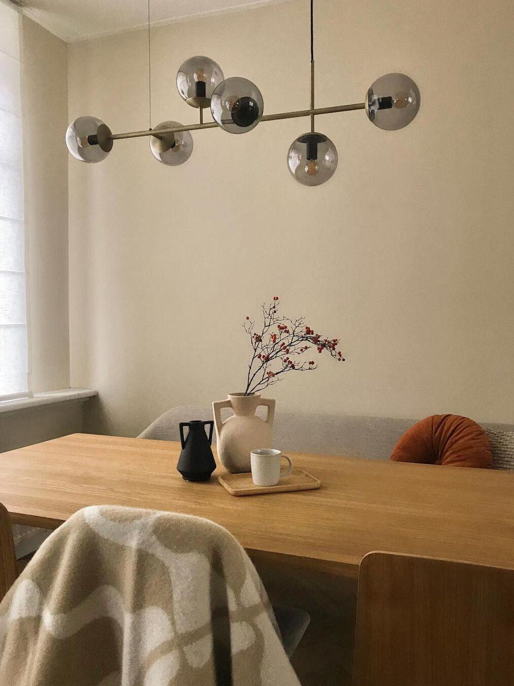 Glass-globe fixture above a mustard-covered table