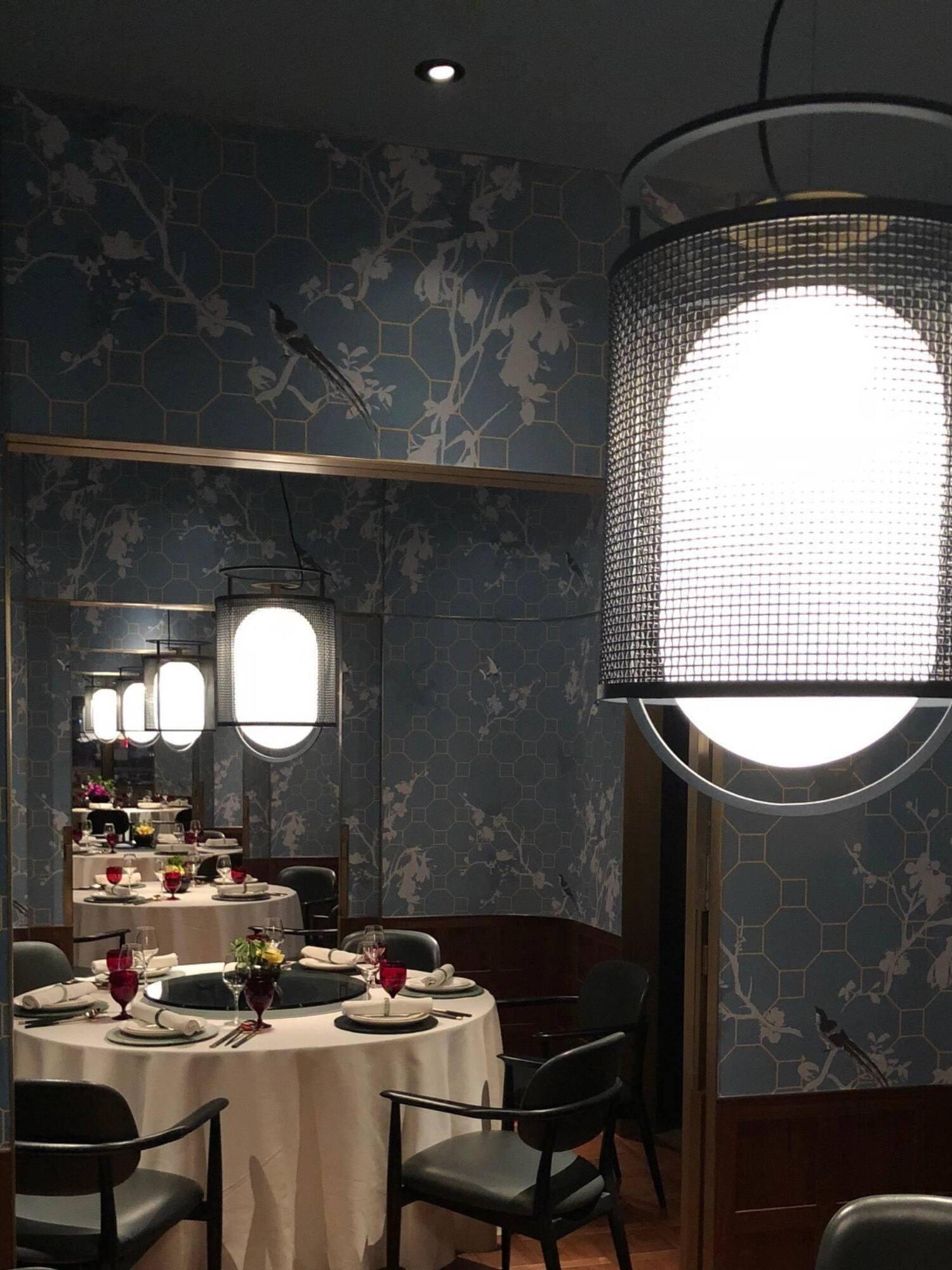 Black lantern pendant close to camera over dining table