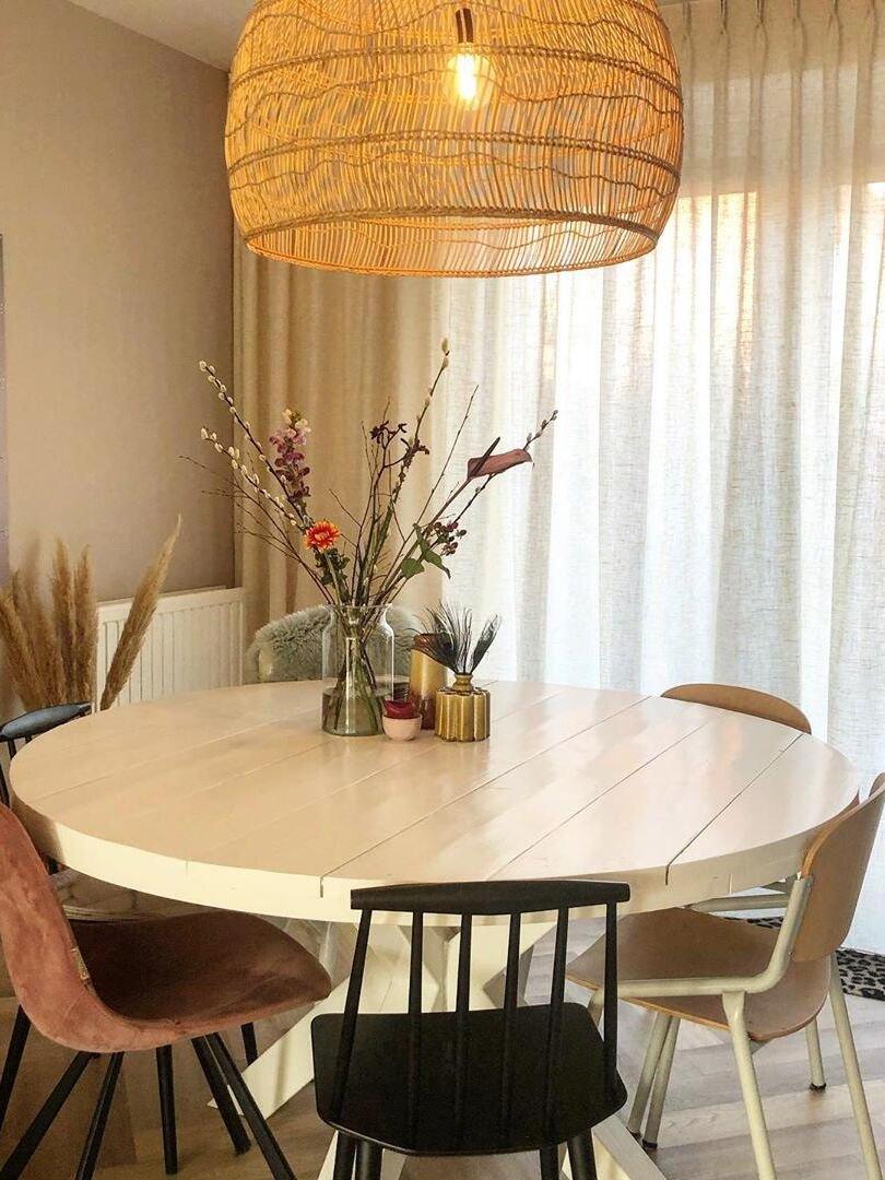 Glowing woven shade over a round dining table