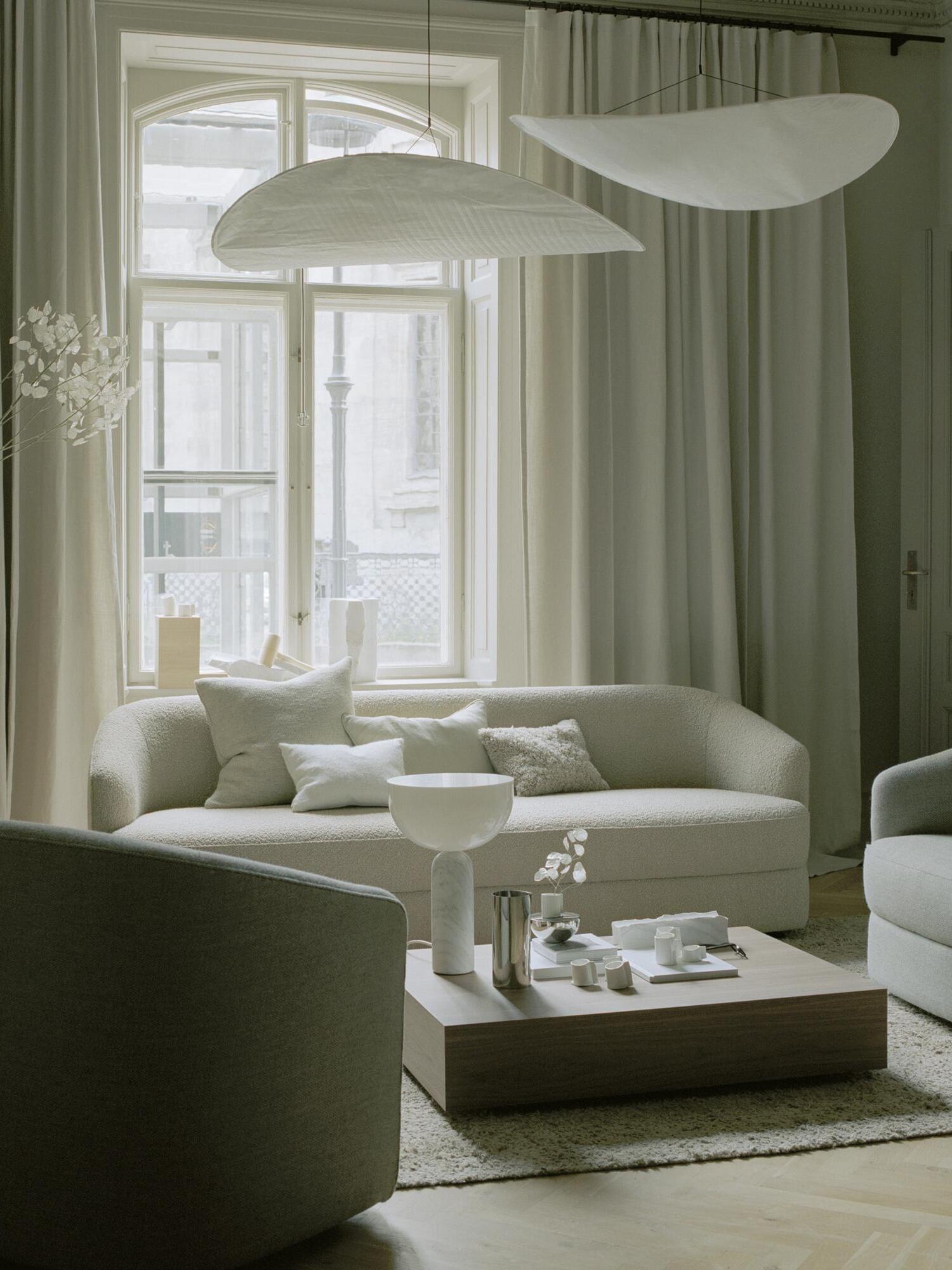 White sculptural shades over pale green seating