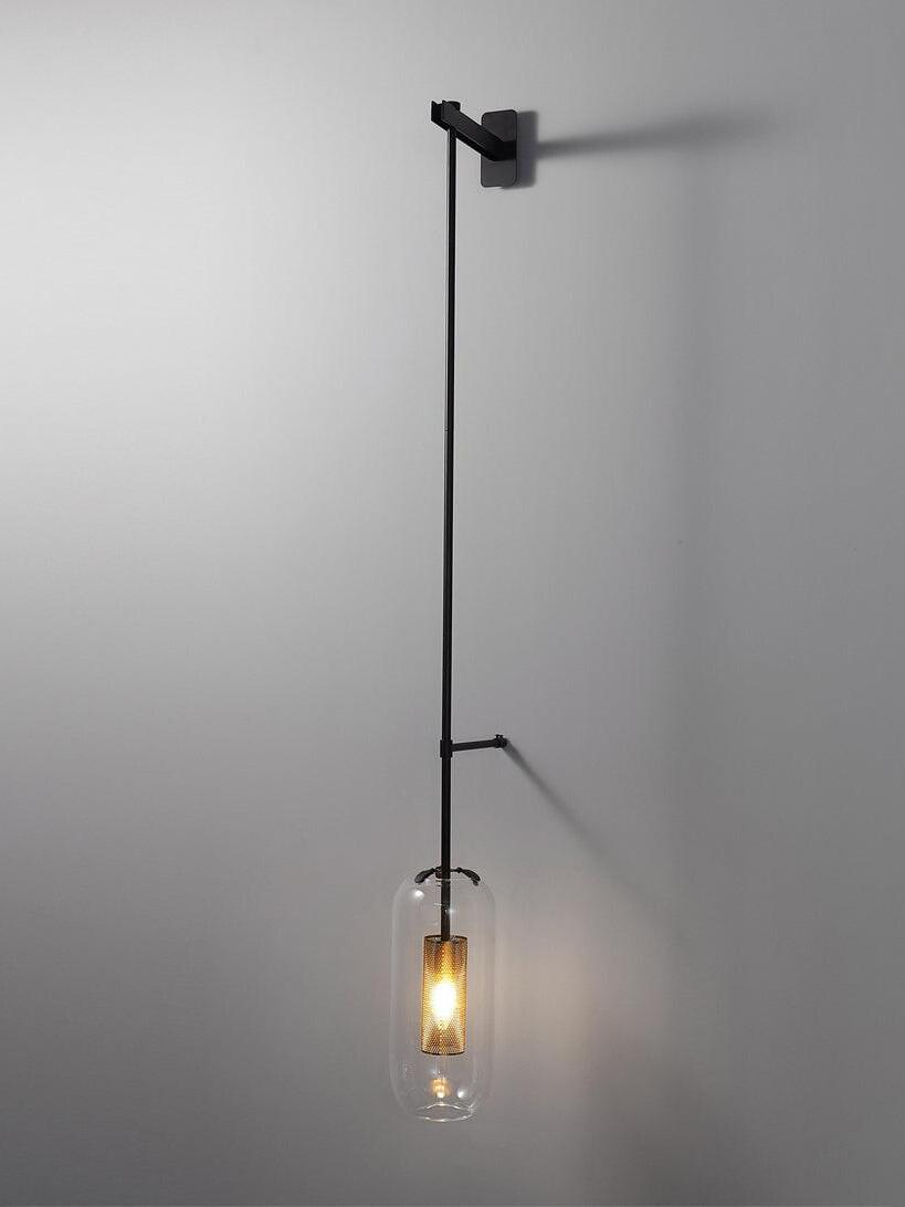Black Vadim rod and rectangular bracket with a glowing clear capsule shade against a gray wall
