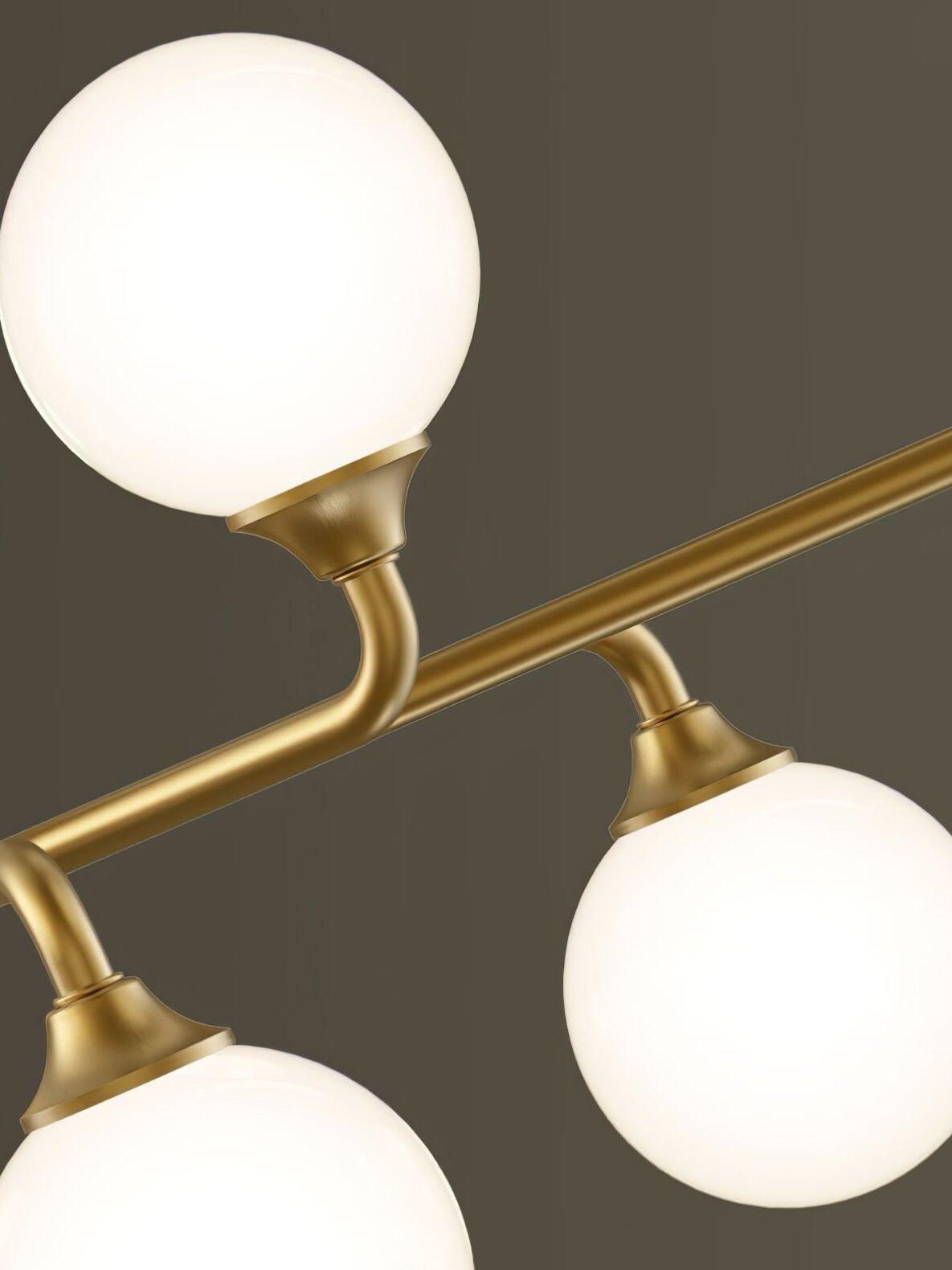 Close white glass globes on bent brass arms