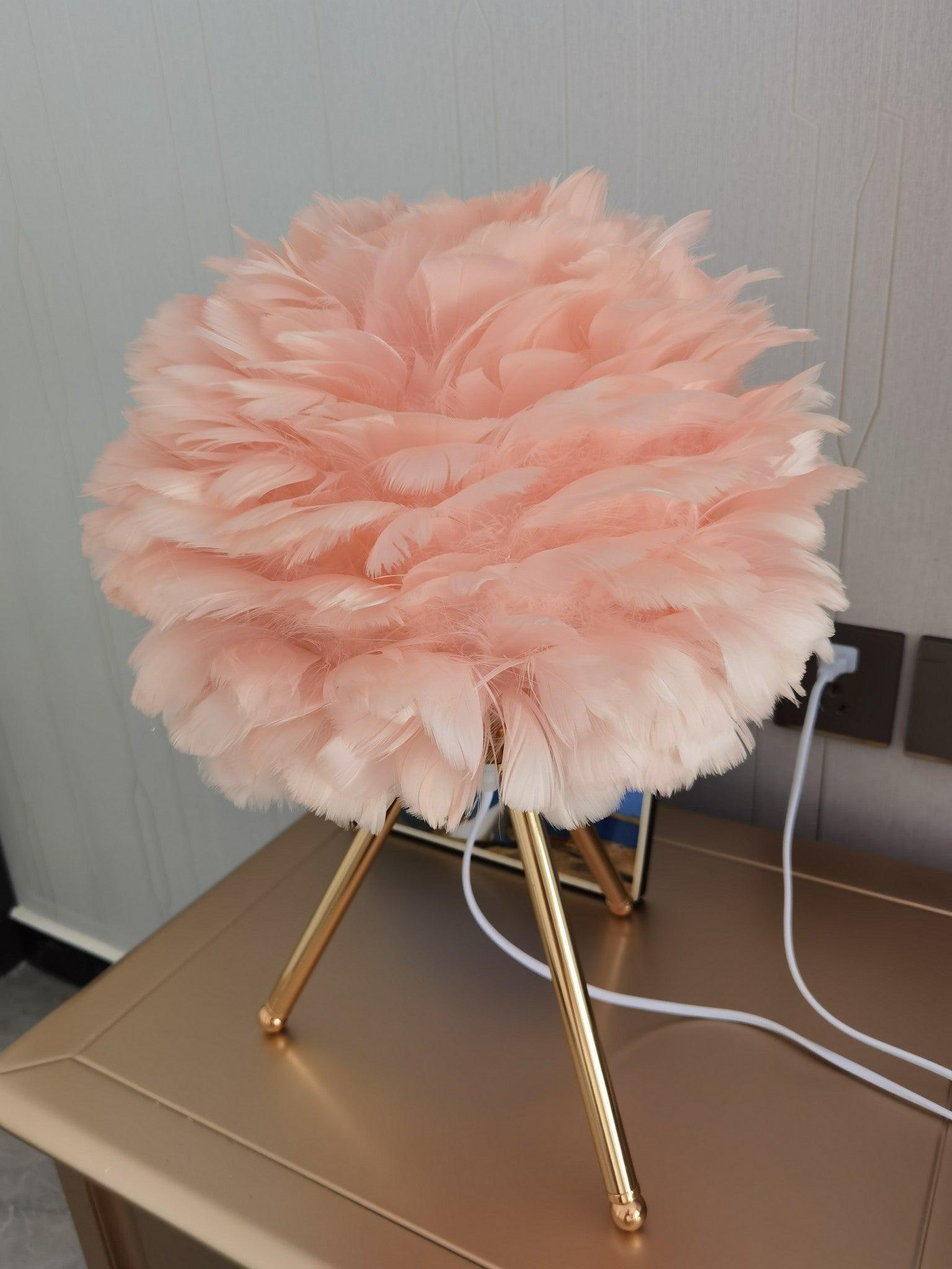 Pink feather shade and gold tripod with white cord