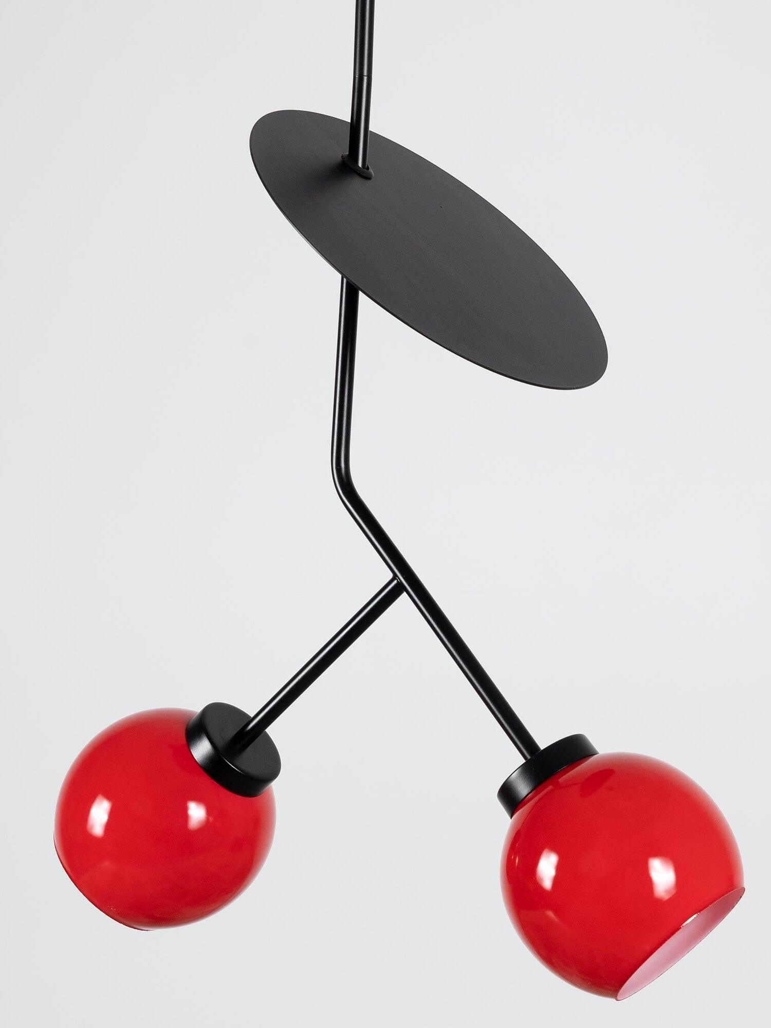 Black oval leaf-like disc above forked stems and two Red shades