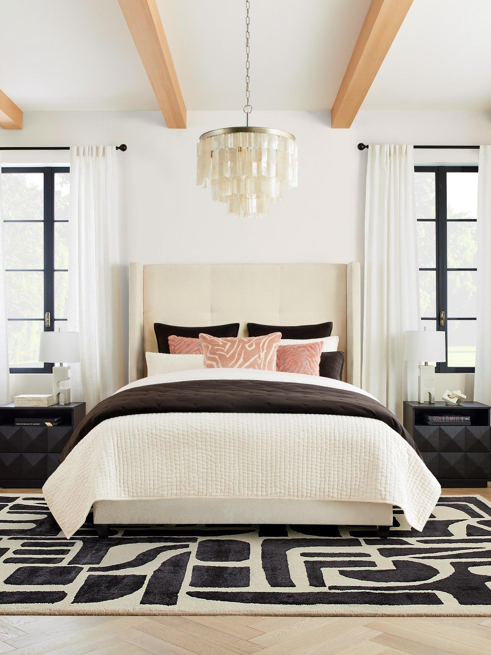 Skye shell pendant suspended above a bed