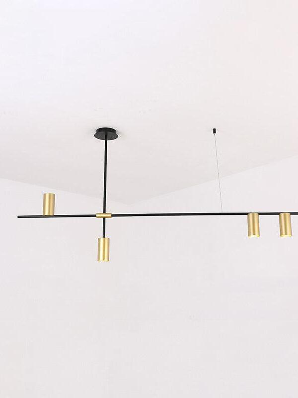 Black and gold-coloured linear fixture with fine suspension lines