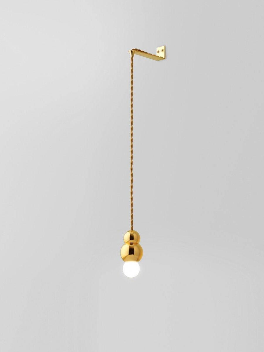 Gold Flex wall light with twisted cord and small bulb