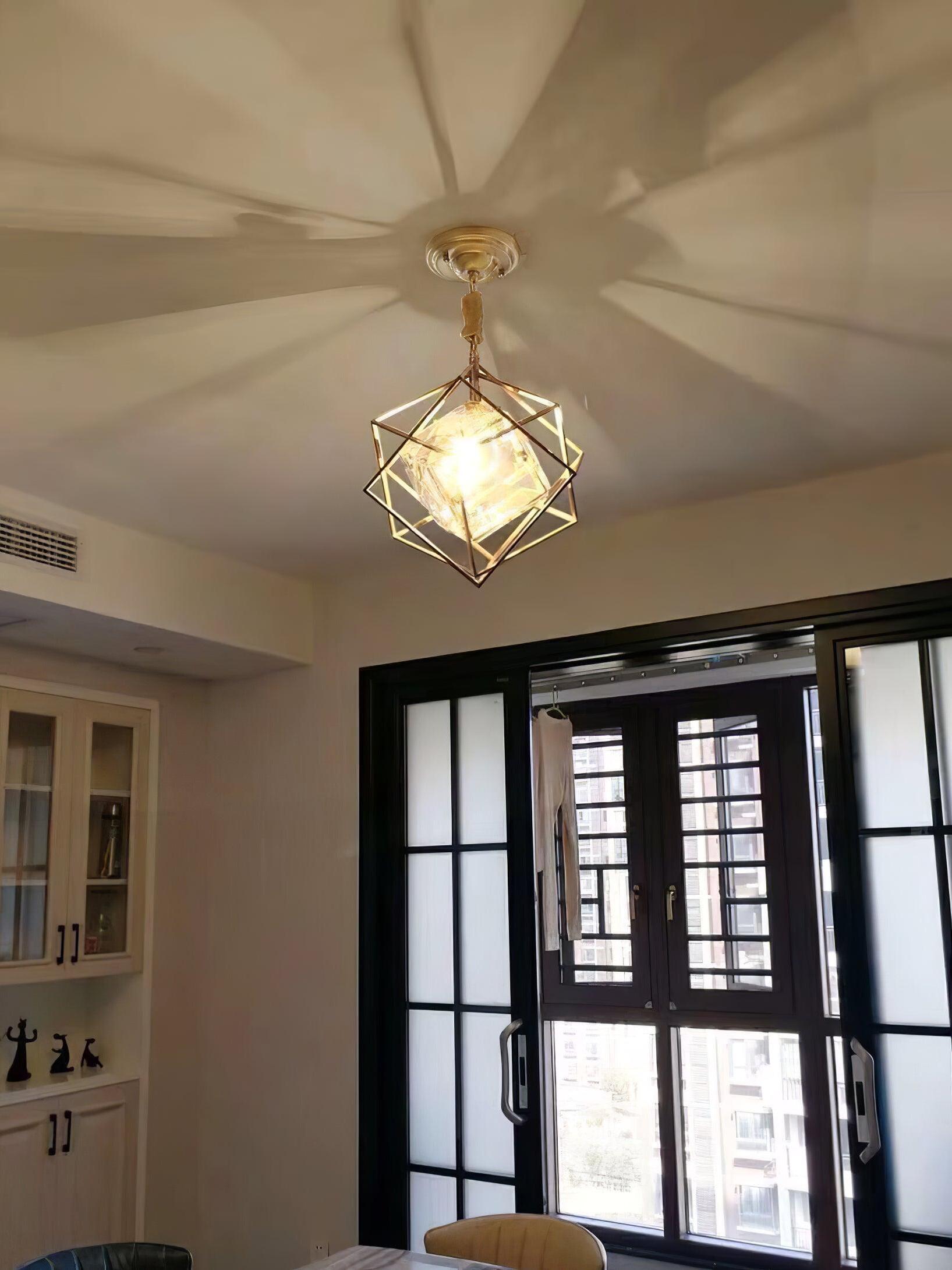 Glowing Epic geometric pendant beside a dark-framed window with patterned light visible on the ceiling