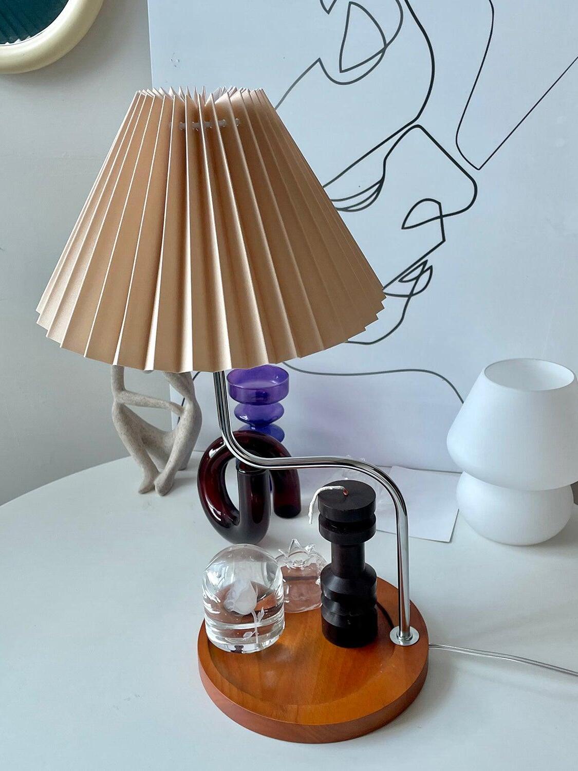Brown pleated shade above round wooden tray