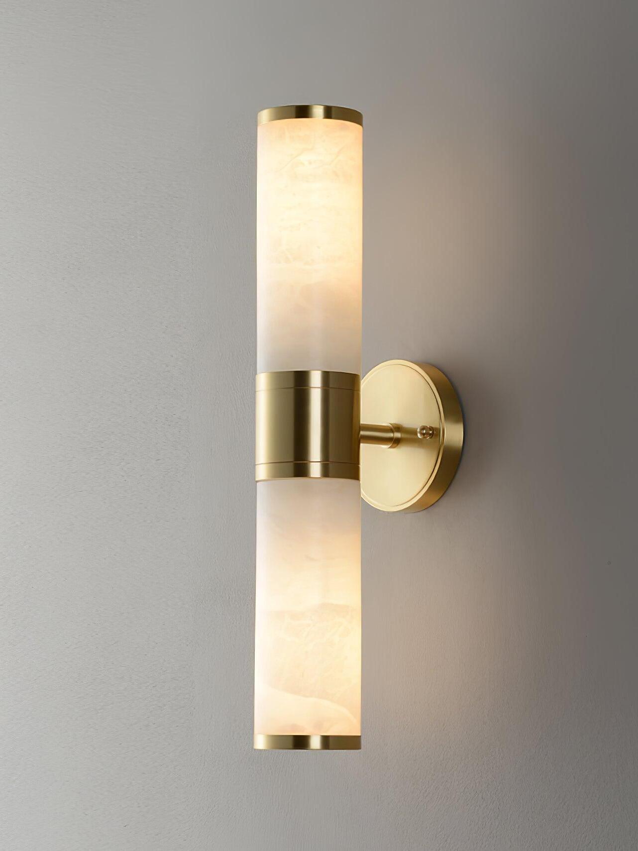 Tall sconce with lit stone sections above and below brass centre
