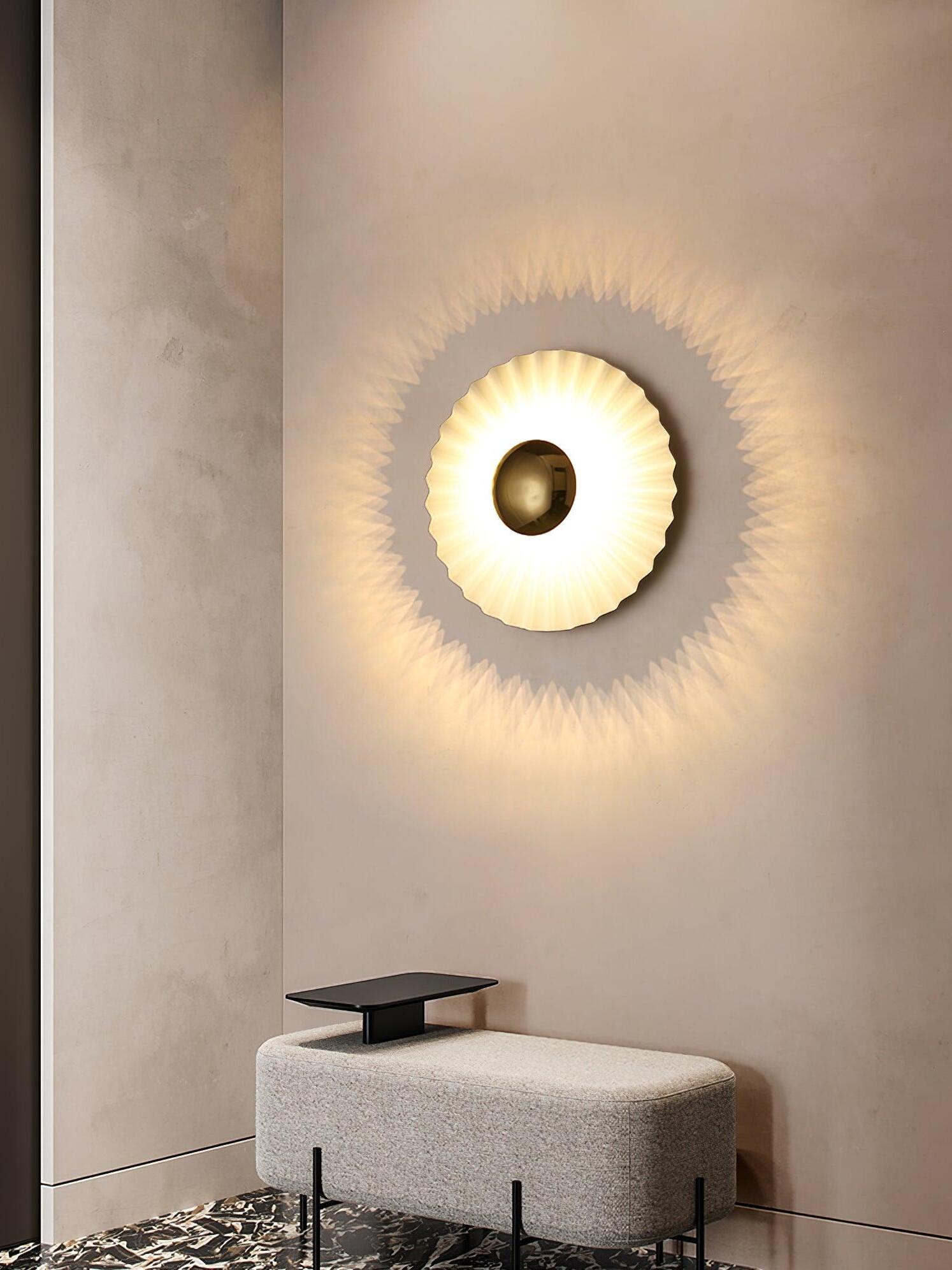 Lit pleated disc with halo on beige wall