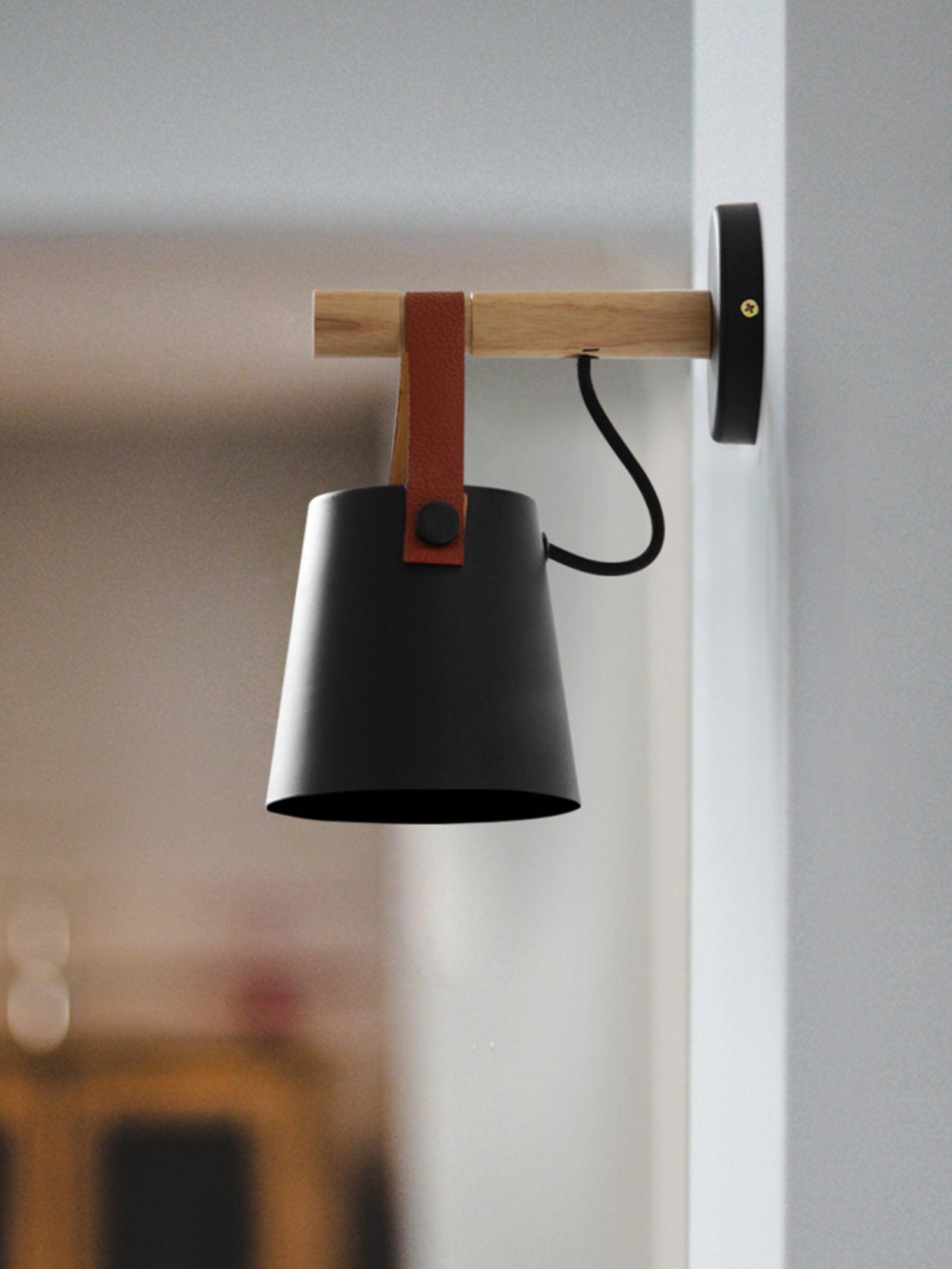 Black tapered shade with looped strap and wooden arm