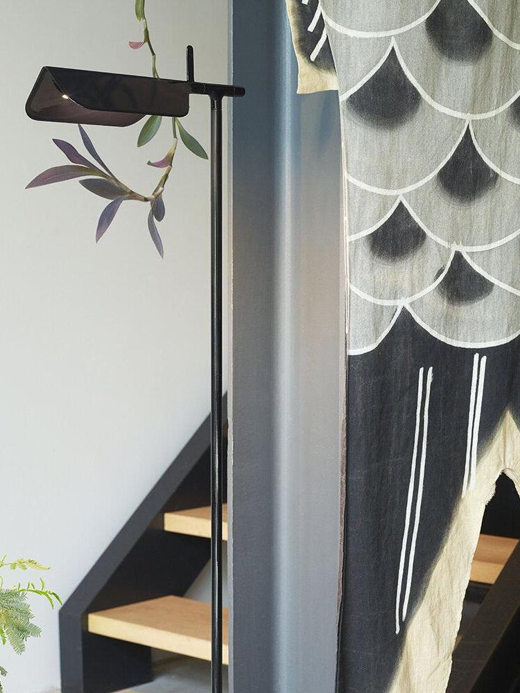 Black floor lamp near a staircase