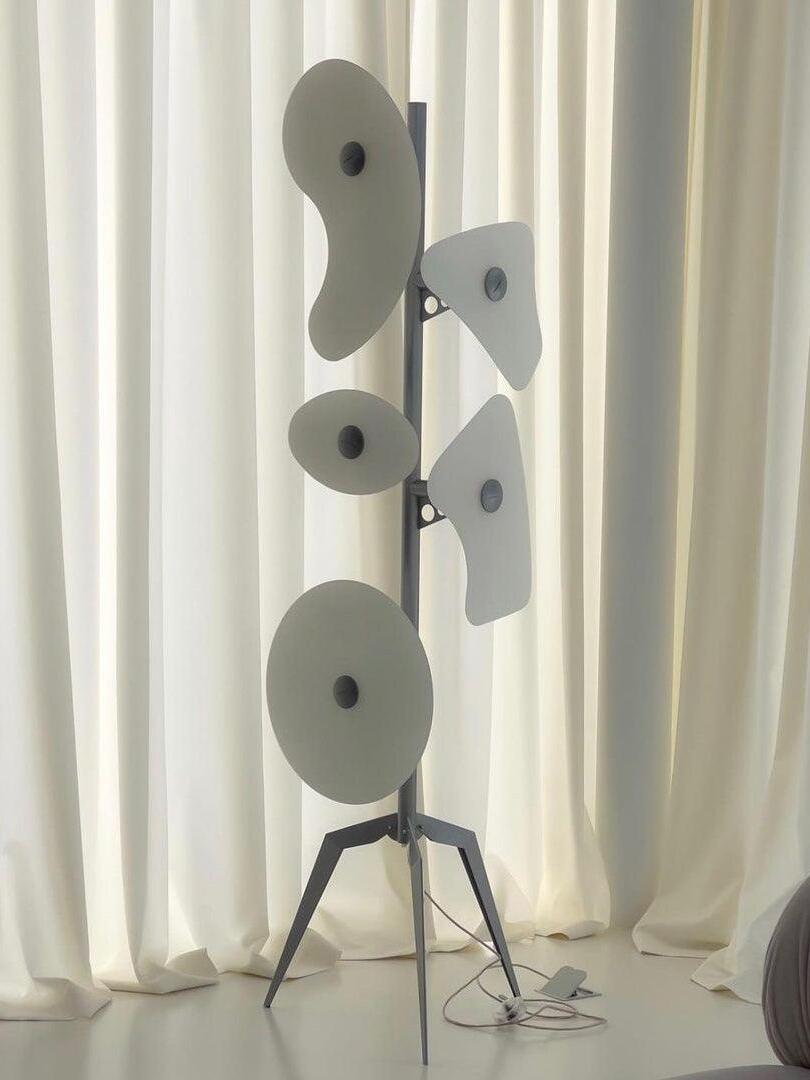 White panel floor lamp near pale curtains