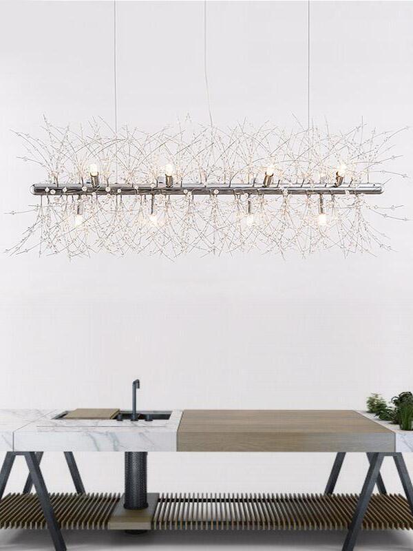 Chrome linear glass chandelier above a minimalist table
