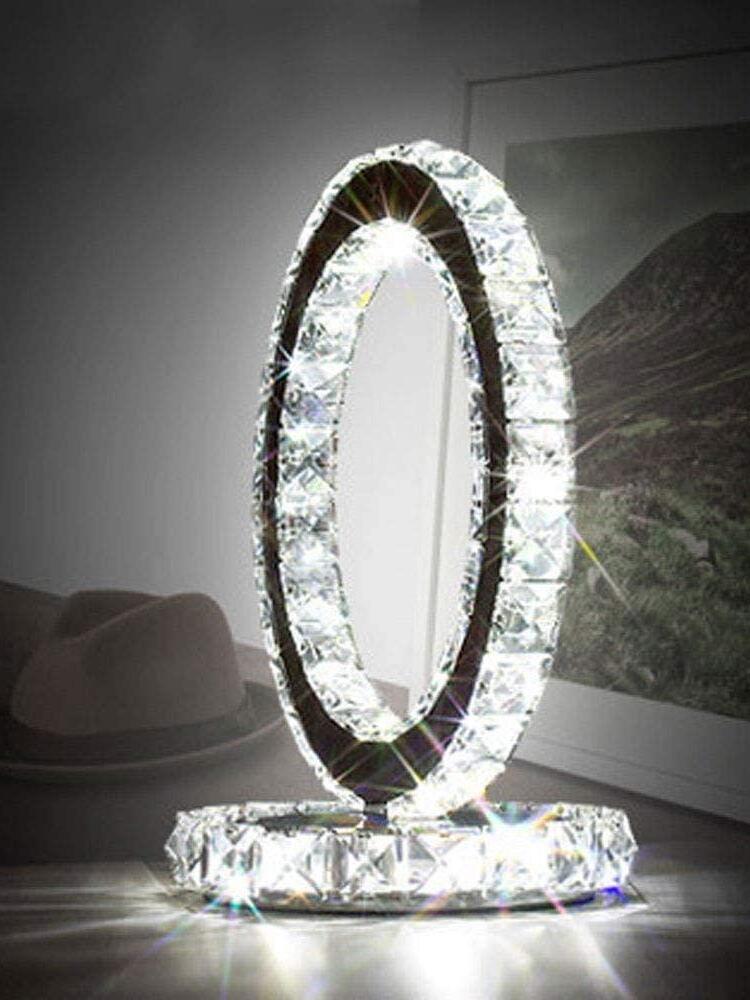 Angled illuminated ring lamp casting reflections onto a tabletop beside a hat