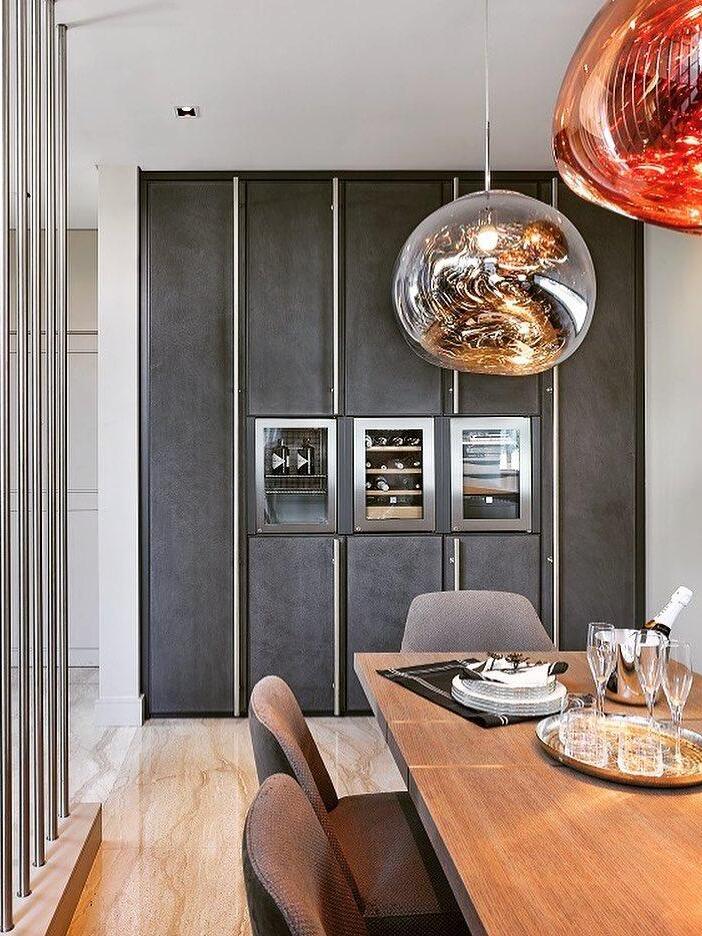 Silver pendant above a wood table